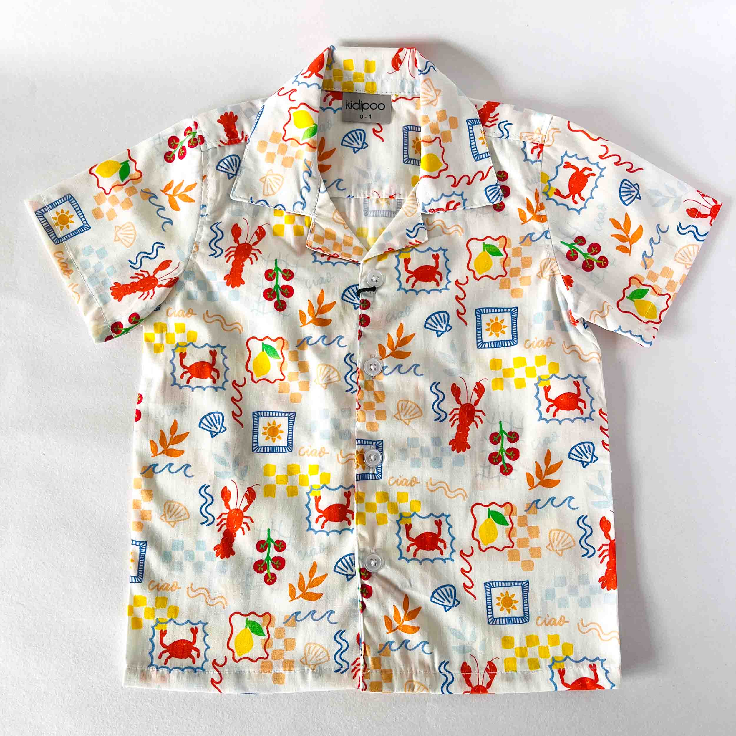 Childrens shirt with colourful sea-themed pattern on a white background