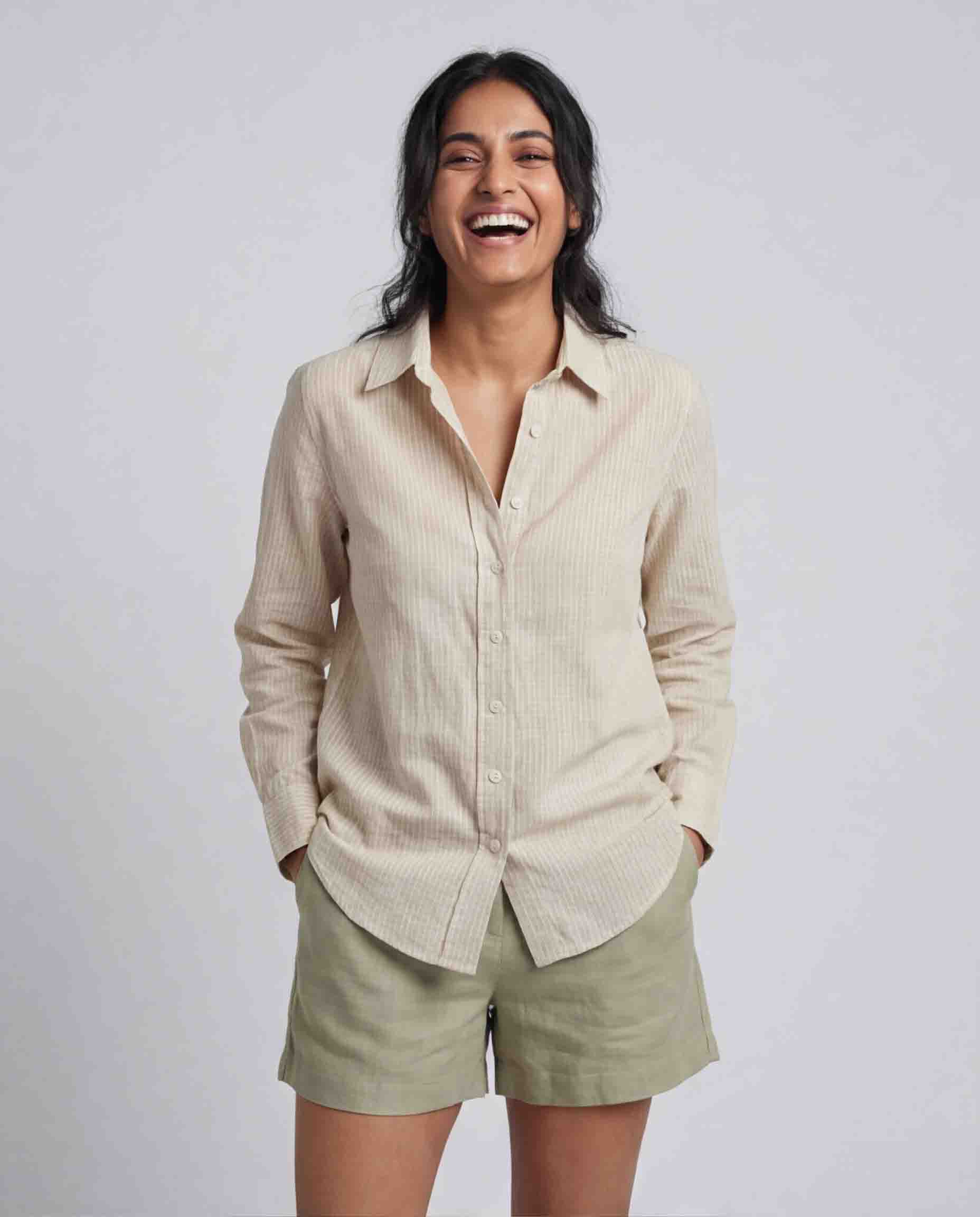 Woman wearing beige striped cotton linen shirt front view casual office wear