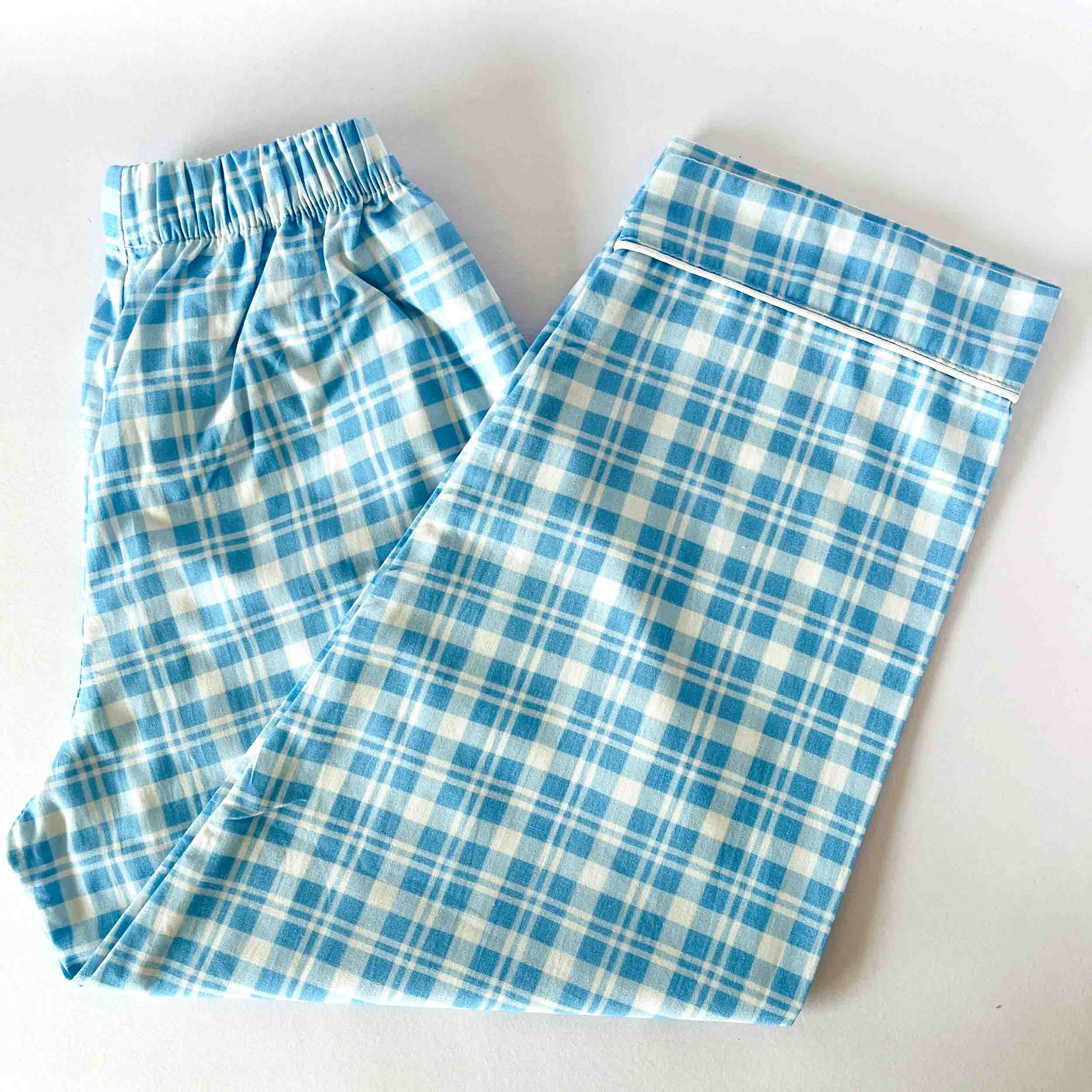 Blue and white plaid pants on a light background