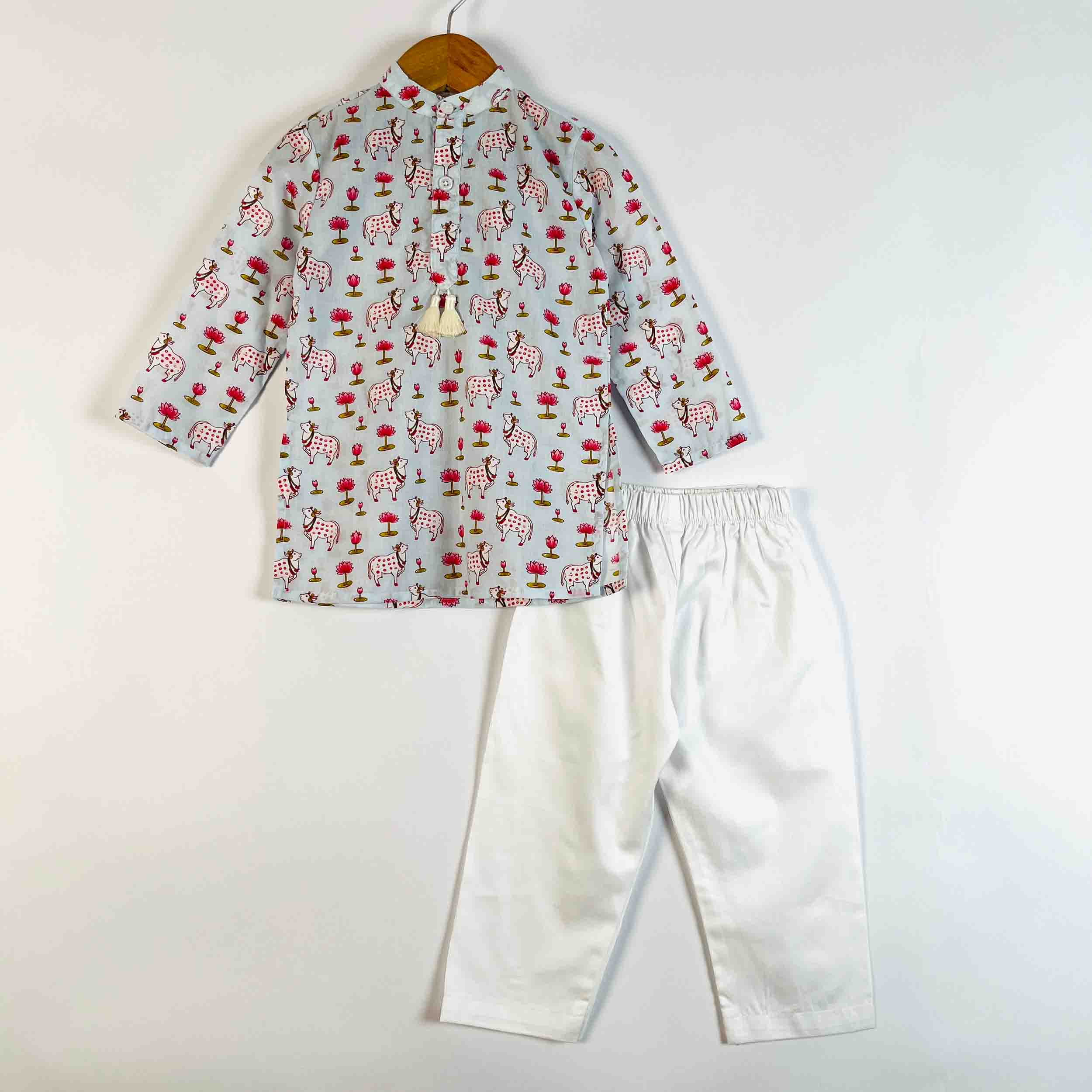 A children's two-piece outfit set consisting of a light gray long-sleeve shirt with a red and white elephant print and white pants, displayed on a wooden hanger against a plain white background.