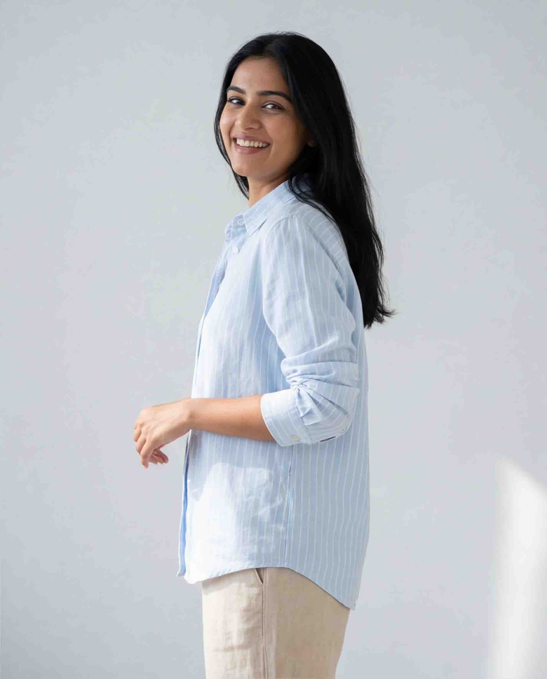 Light blue striped women's shirt side view casual office wear