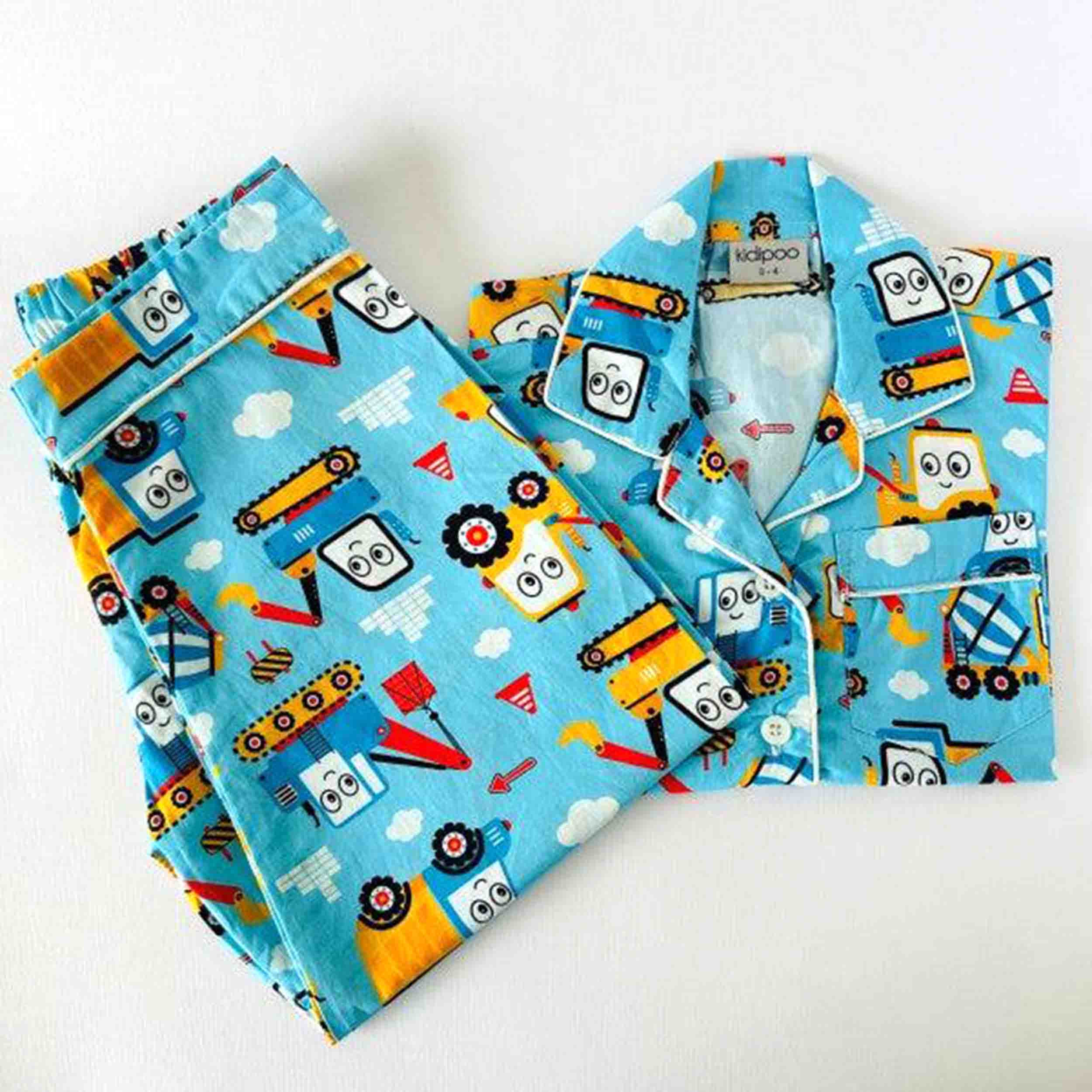 Children's pajama Shirt and pants with cartoon construction vehicle pattern on a blue background
