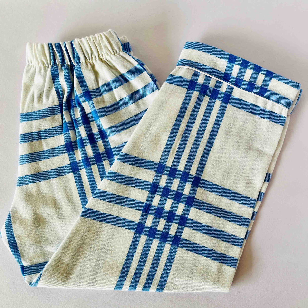 Blue and white checkered fabric on a light gray background