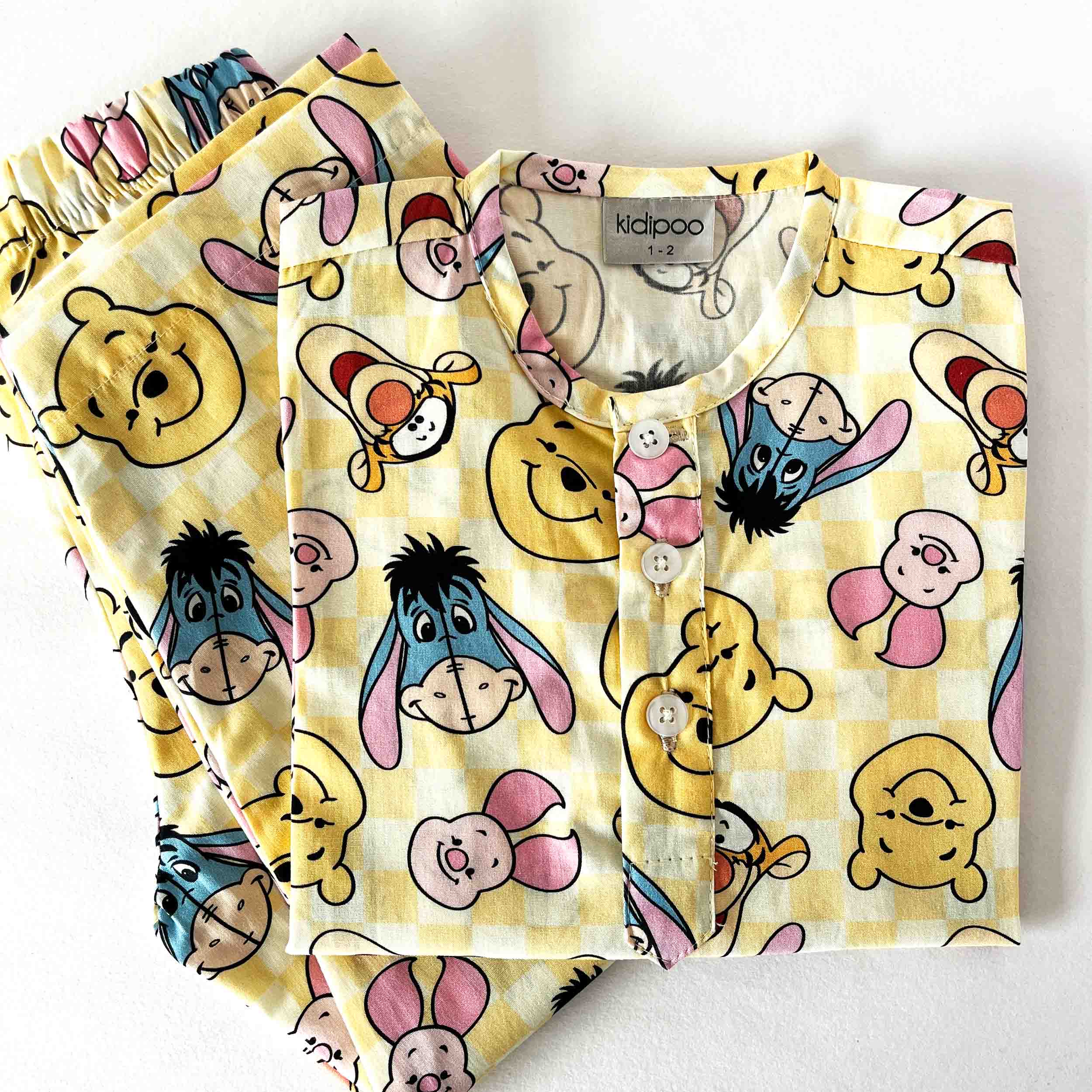 Children's pajama set with cartoon character pattern on a white background
