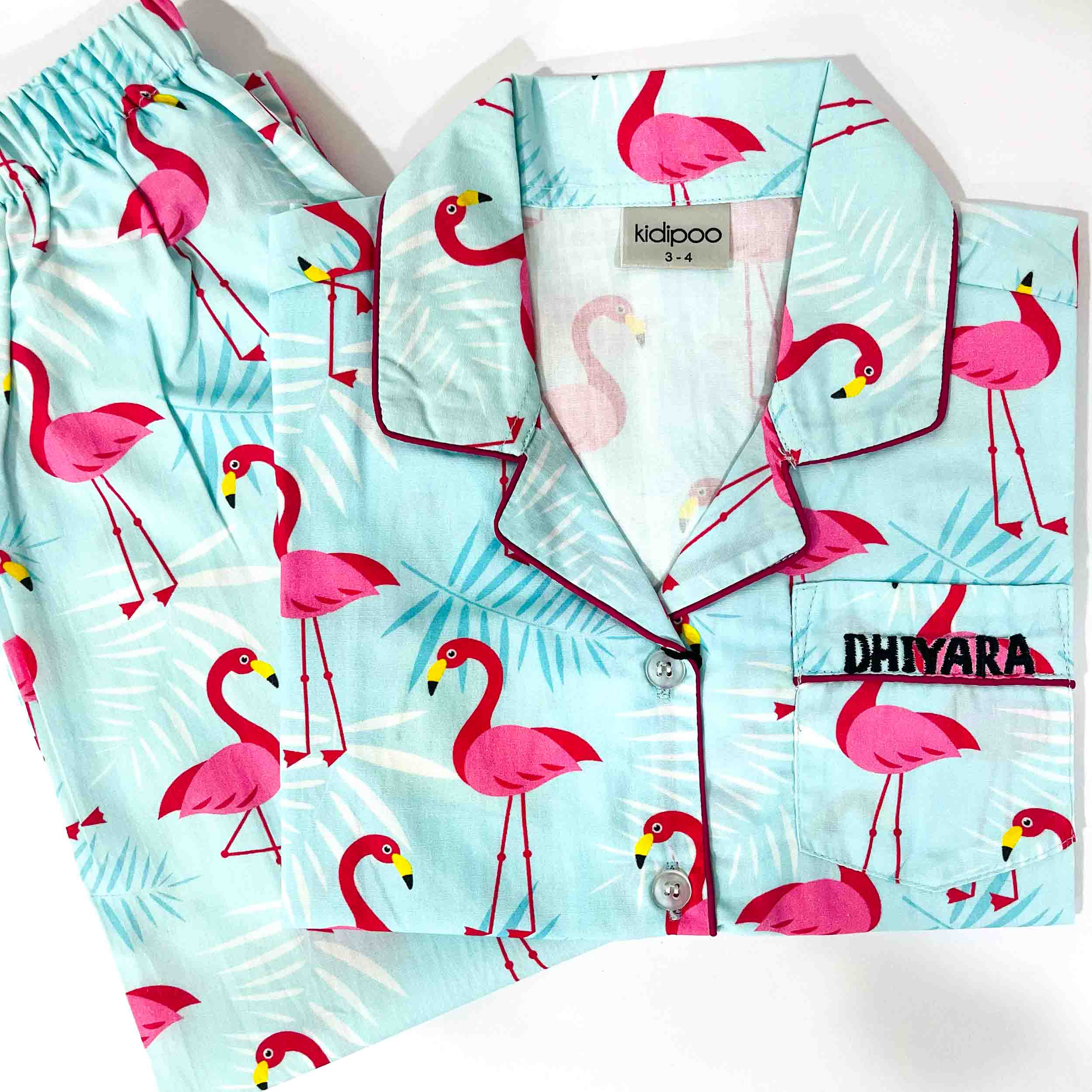Children's pajama set with flamingo pattern on a light blue background