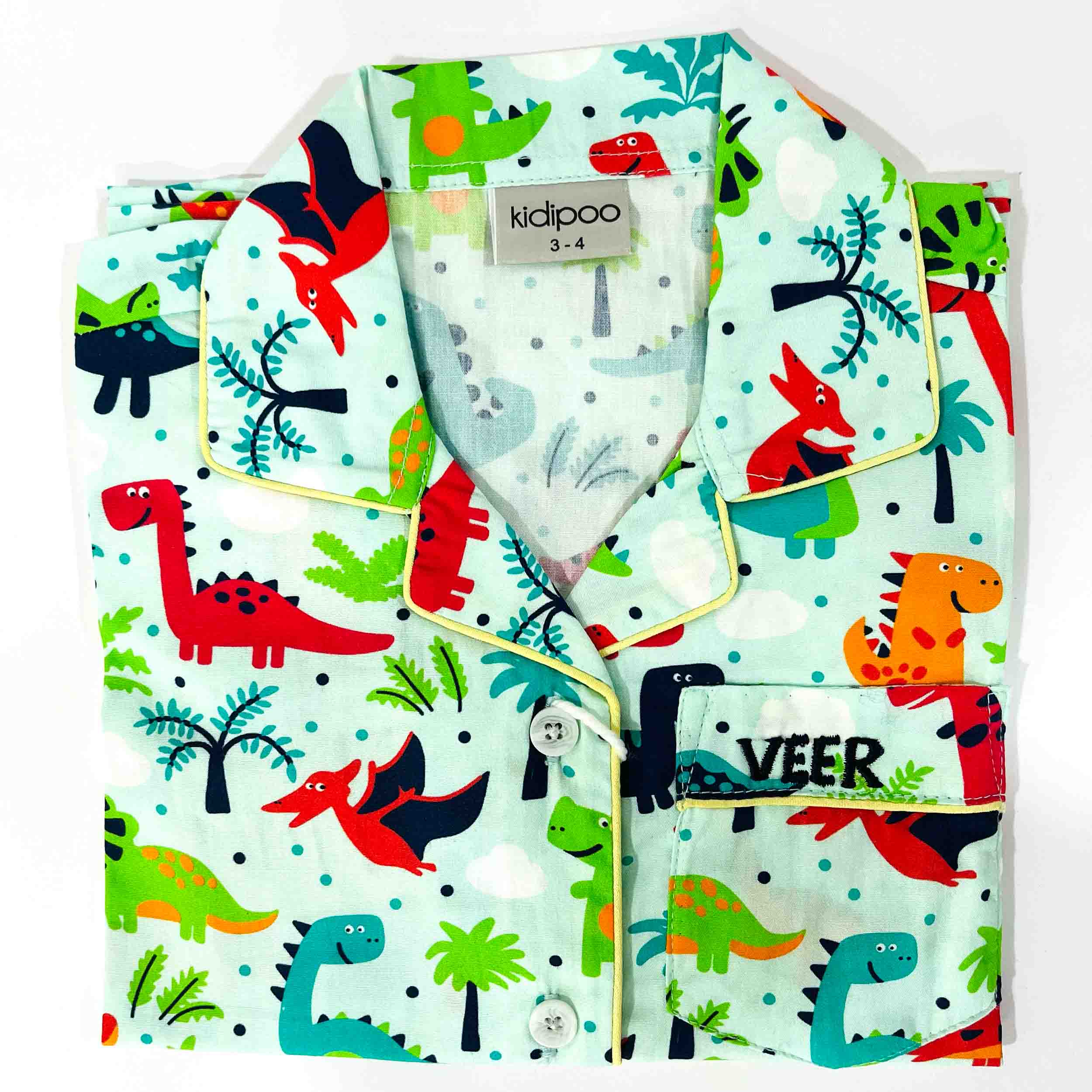 Children's pajama set with dinosaur pattern on a light blue background, featuring the brand 'kidpoo'.
