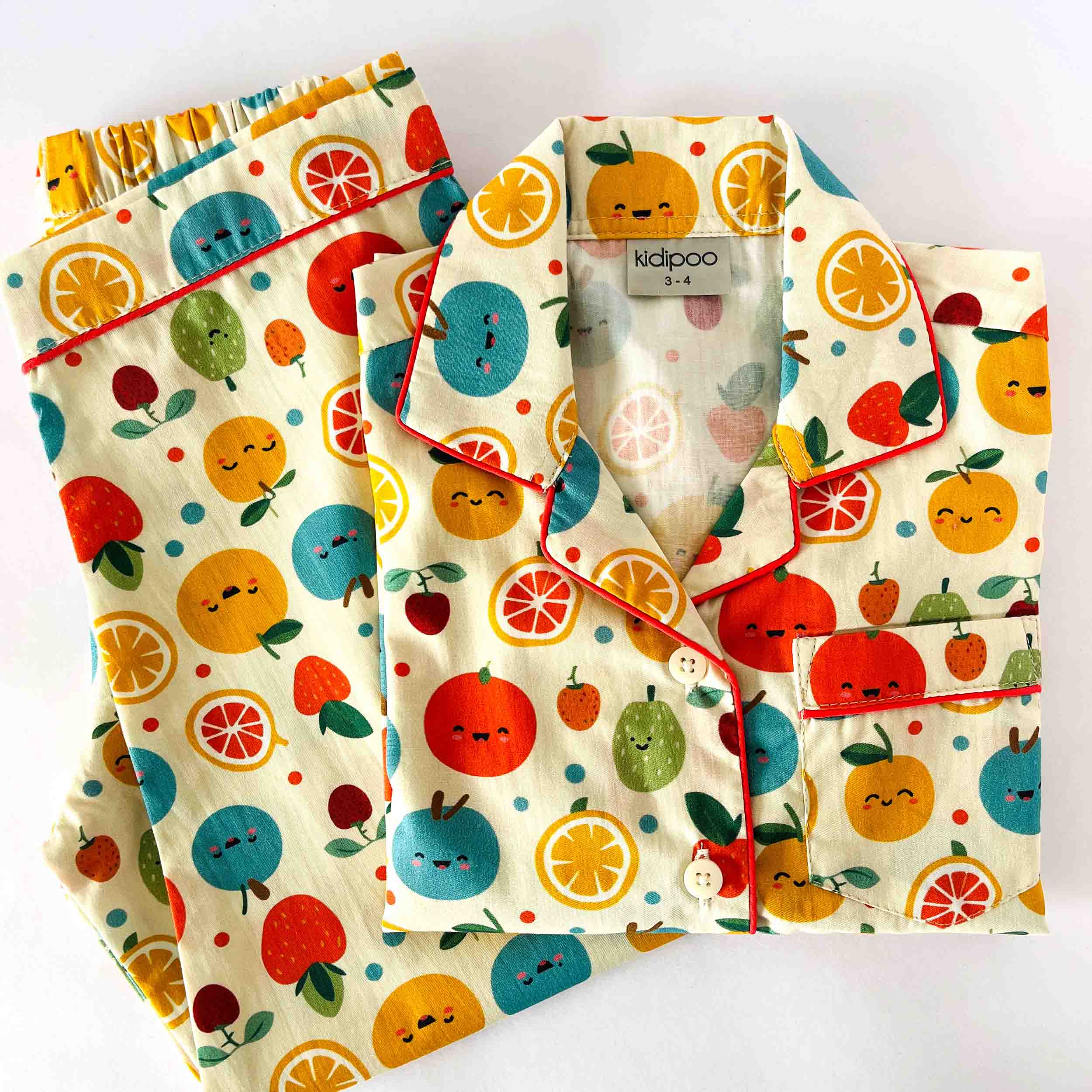 Children's pajama set with fruit pattern on a white background