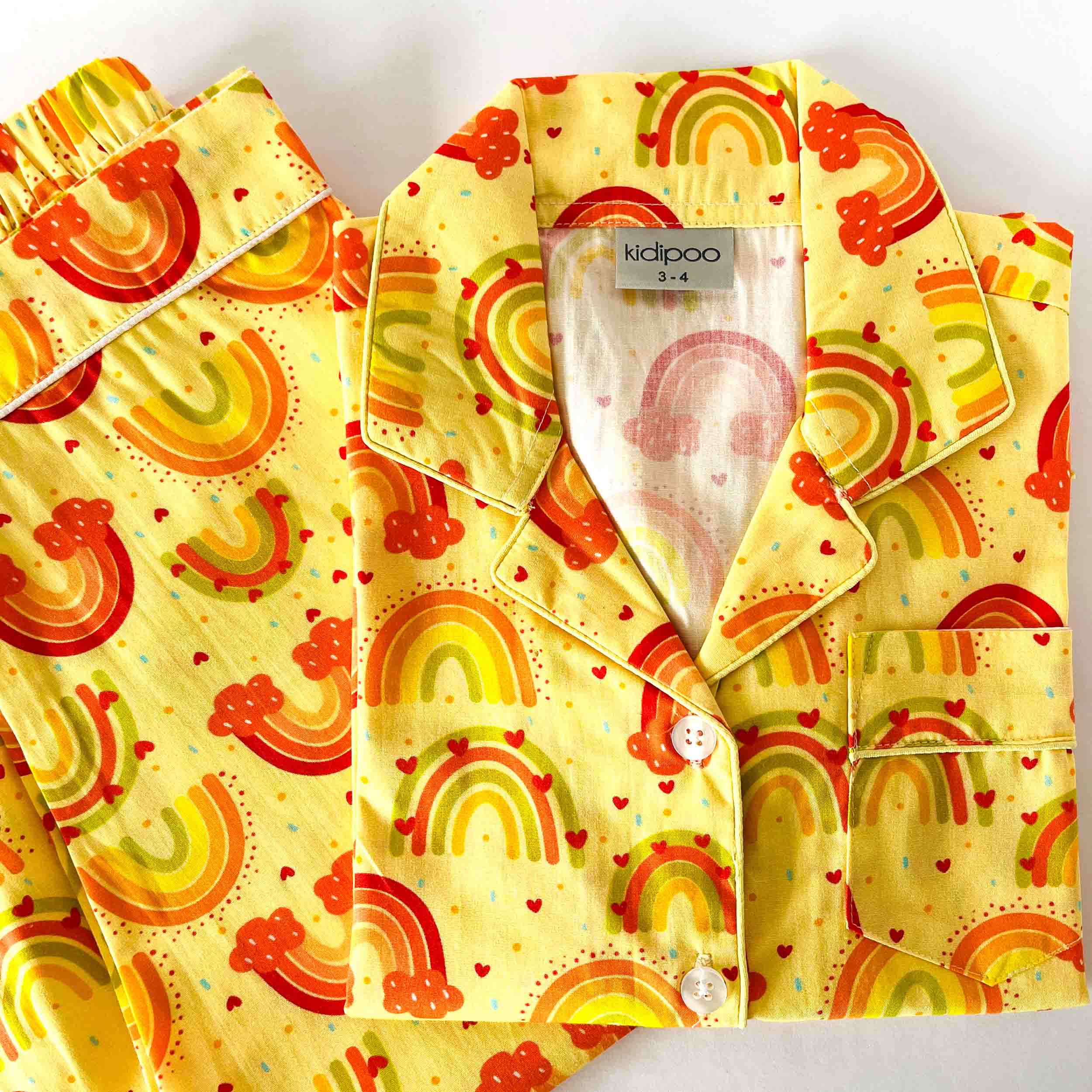 Yellow rainbow print kids night suit soft cotton sleepwear set folded view