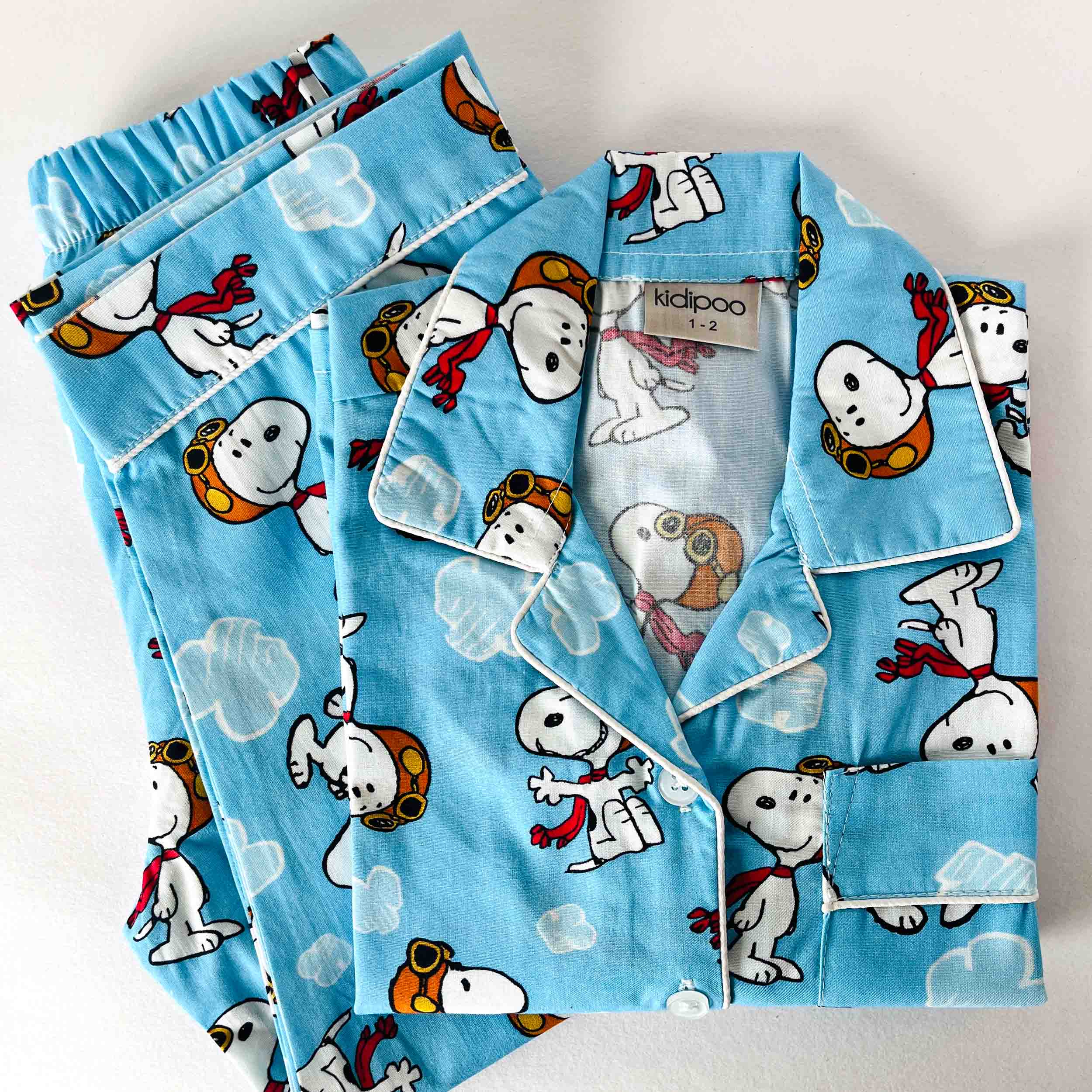 Children's pajama set with cartoon dog design on a light blue background