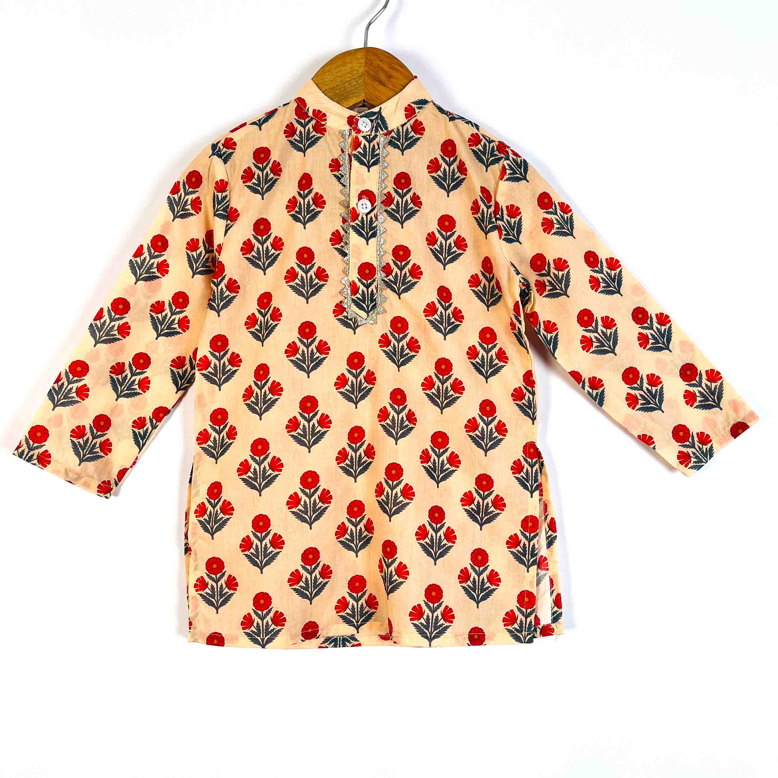 A long-sleeve kurta-style top with a beige base and an all-over red and gray floral block print, hanging on a wooden hanger against a white background.