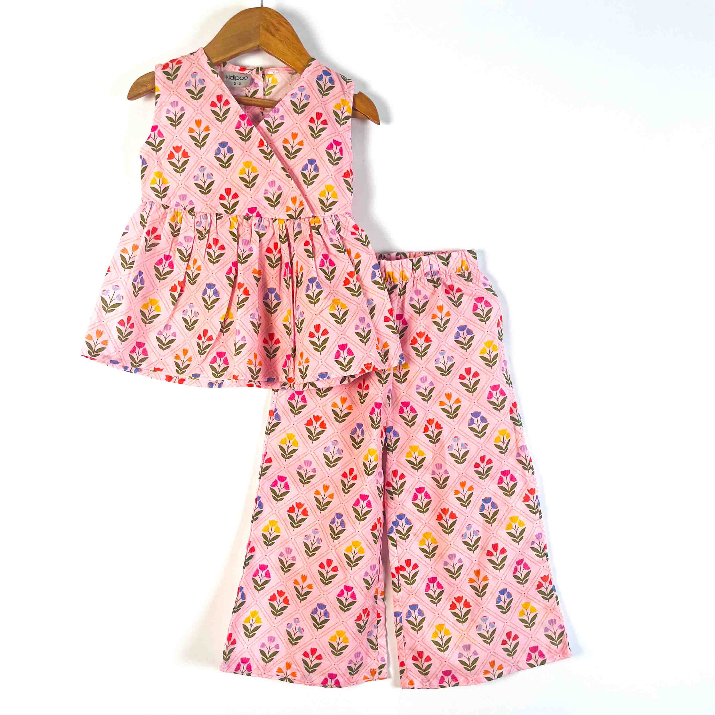 Kids Pink Petals cotton ethnic set with a sleeveless V-neck flared top and matching wide-leg pajama in an all-over floral print