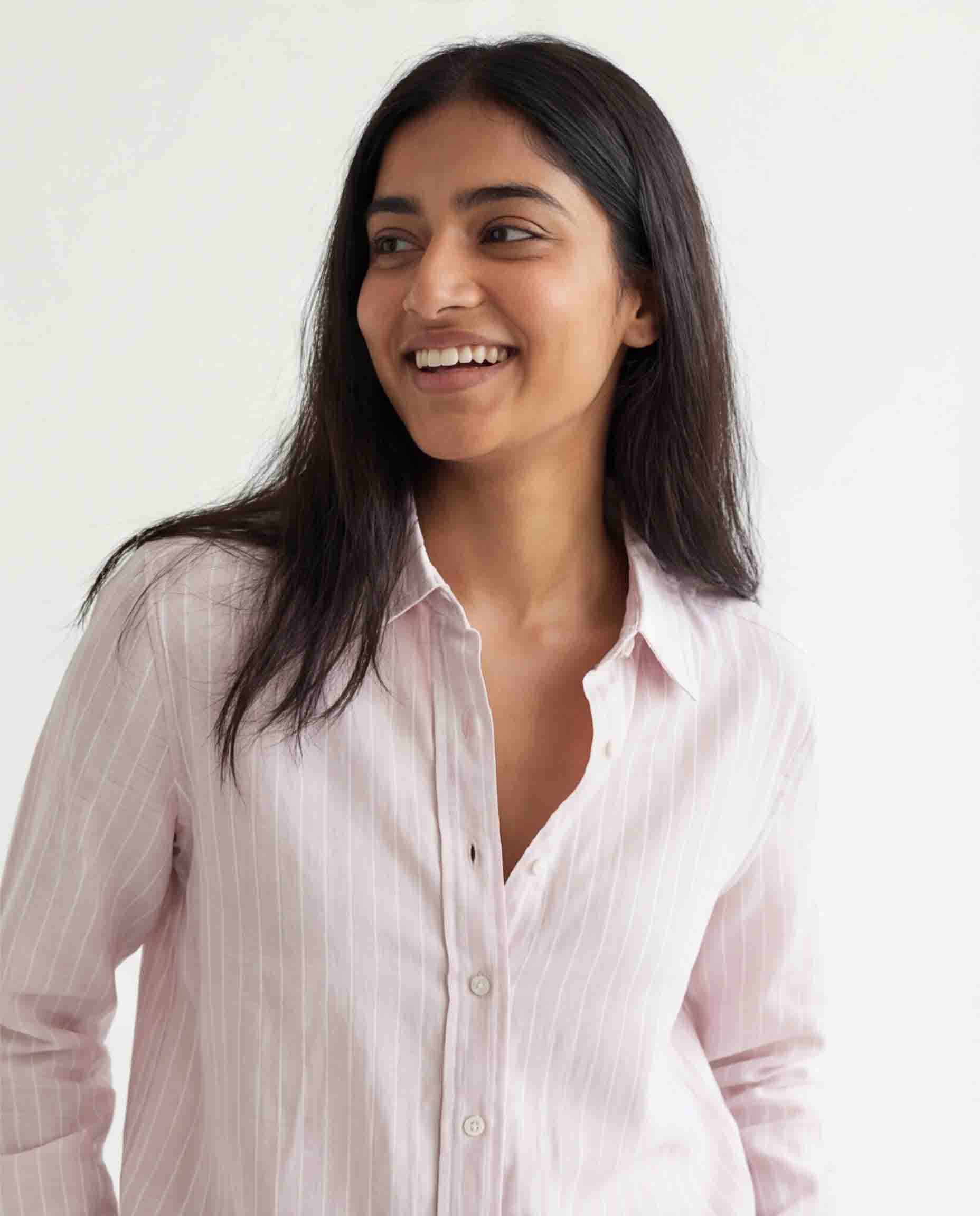 Woman wearing light pink striped cotton shirt front view casual formal wear