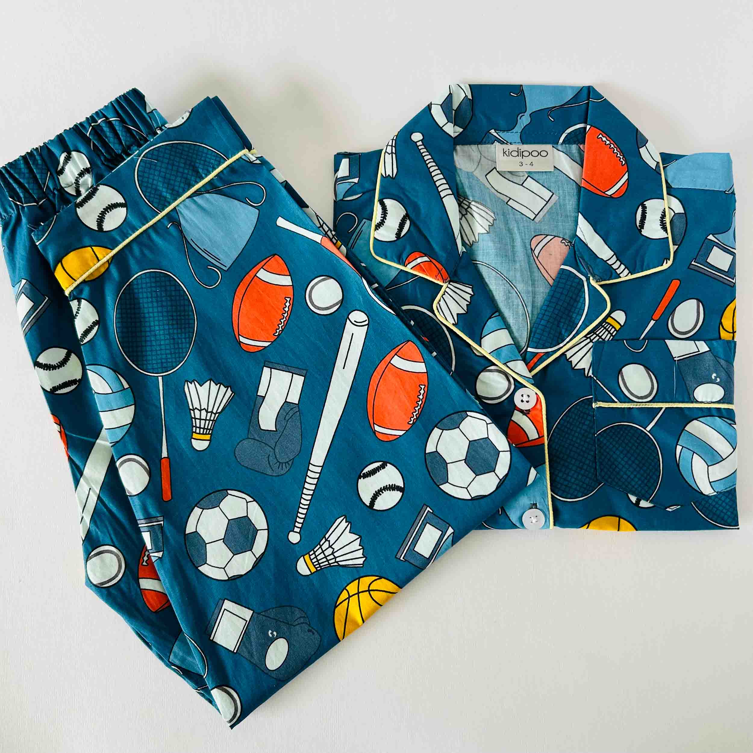 Children's pajama set with sports-themed design on a white background