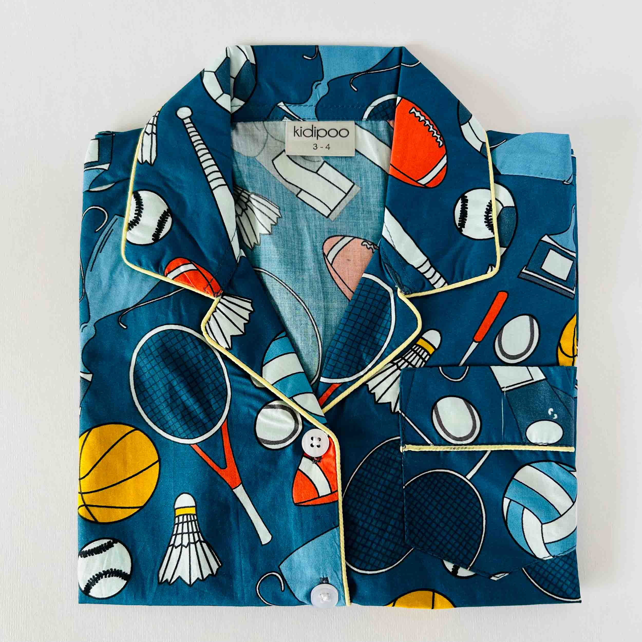 Children's pajama set with sports-themed design on a white background