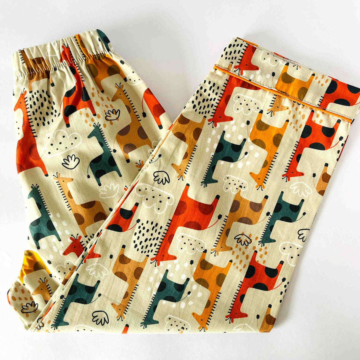 Pair of pajama pants with colorful dog pattern on a white background