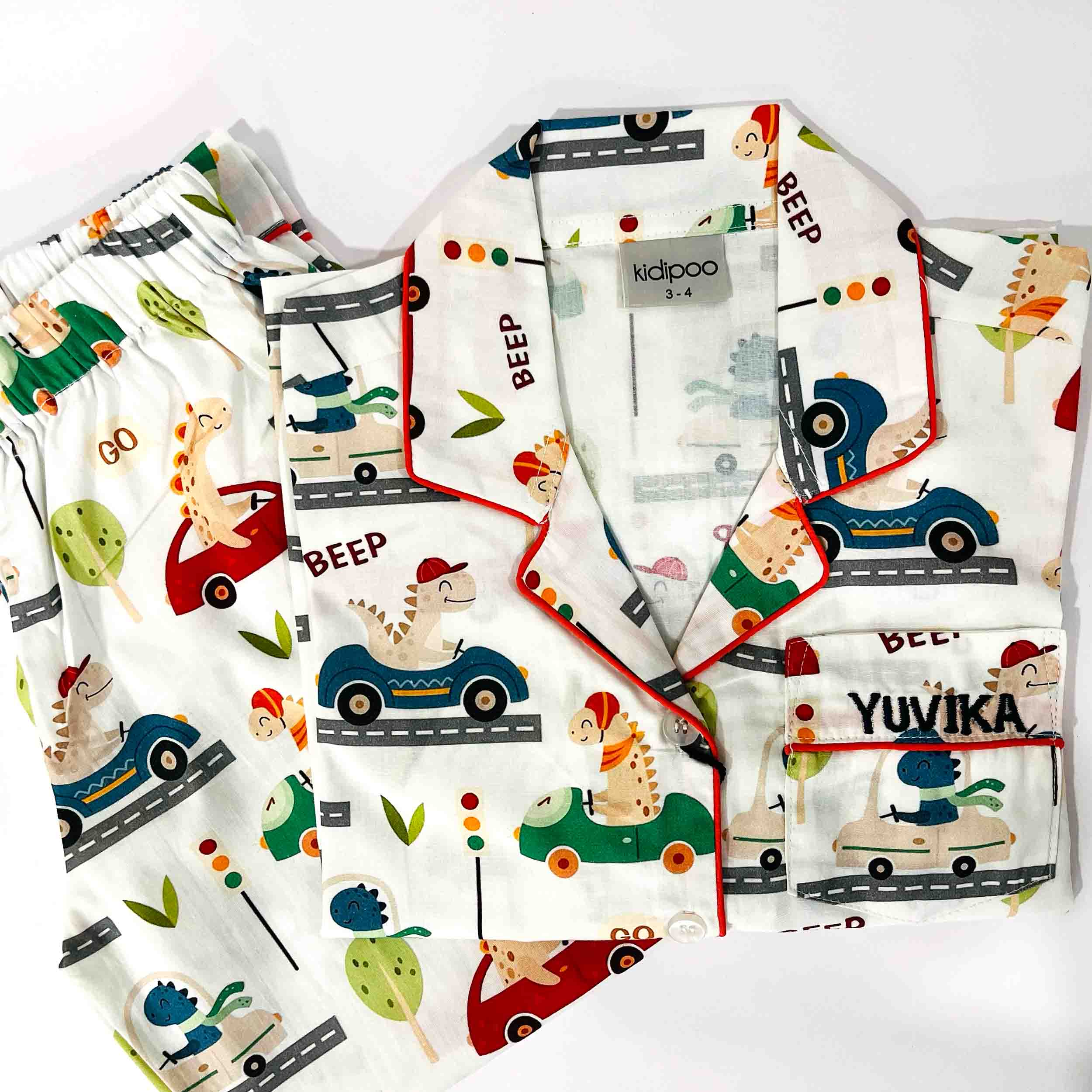 Children's clothing with animal and vehicle prints on a white background