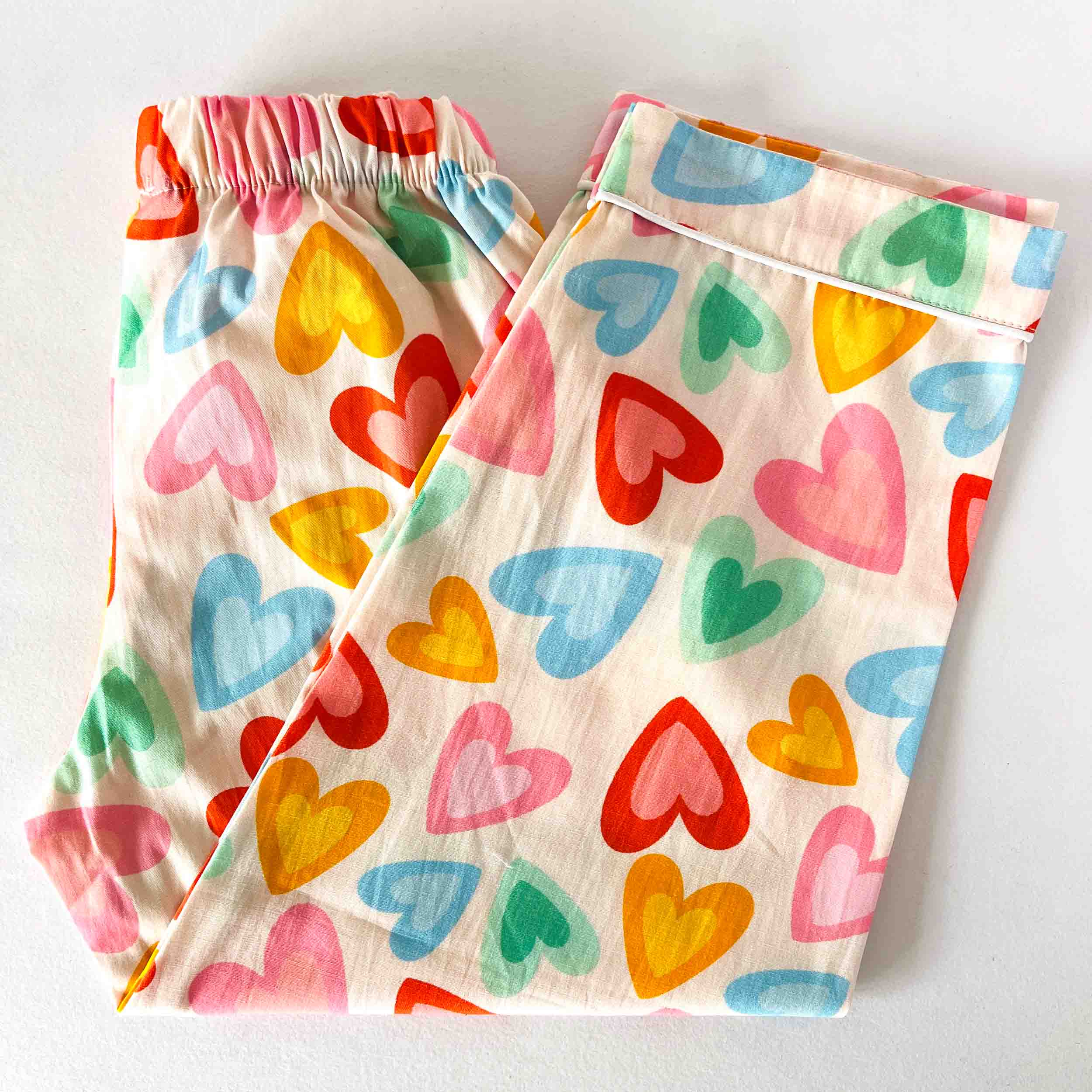 Colorful heart-patterned pants on a white background