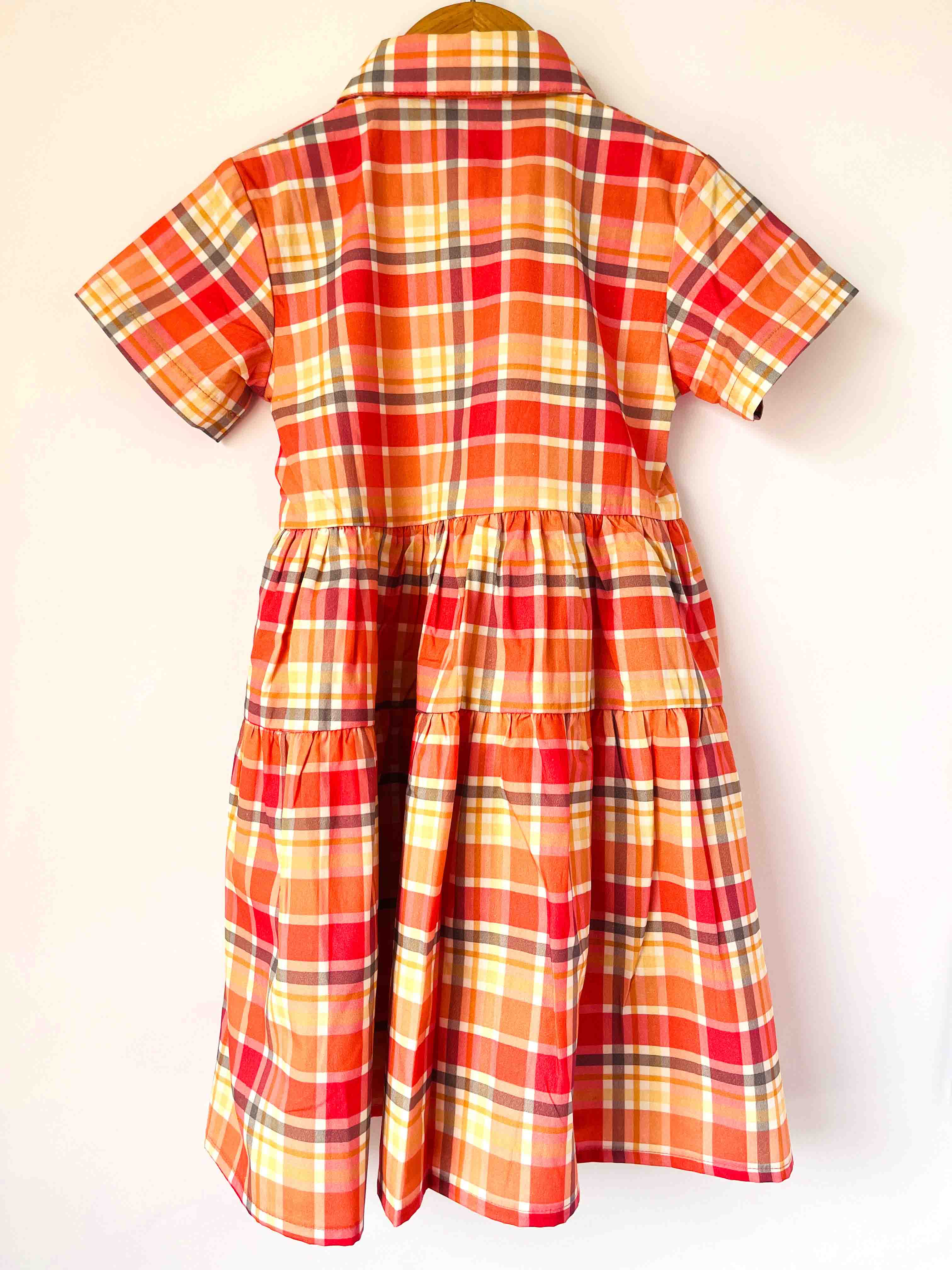 Kids red check cotton dress back view with short sleeves and pleated design