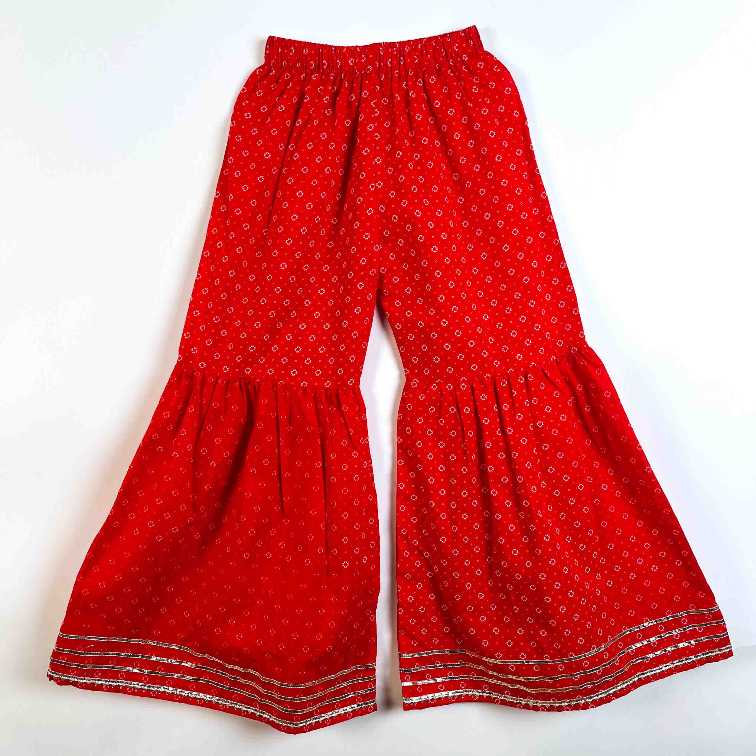 Girls red printed cotton sharara pants with elastic waistband, lace border and comfortable festive fit