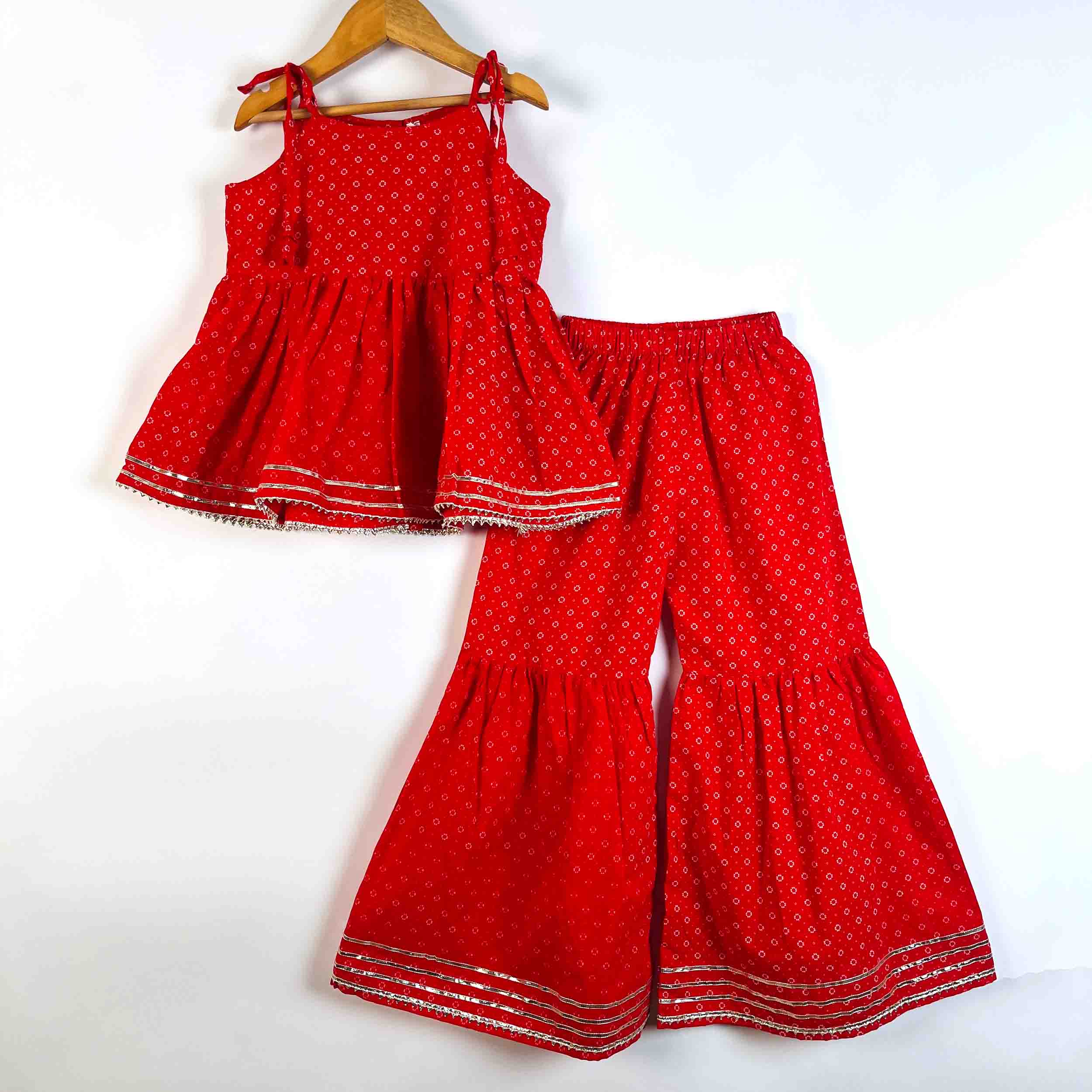 Girls Red Utsav Sharara Set featuring a sleeveless tie-up kurti and matching printed sharara with lace detailing
