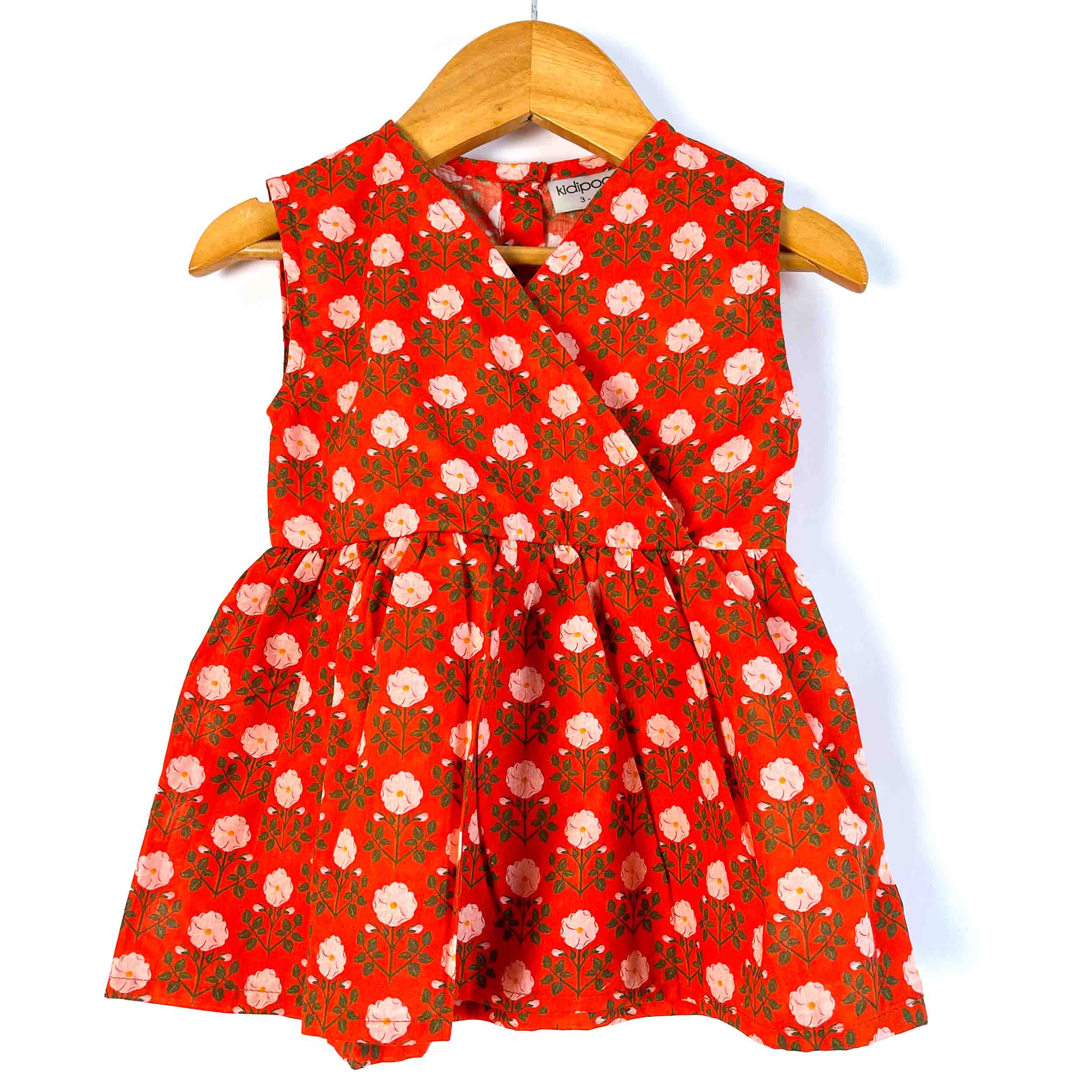 Girls' red floral sleeveless peplum top front view with a V-neckline and gathered waist, made from 100% premium cotton