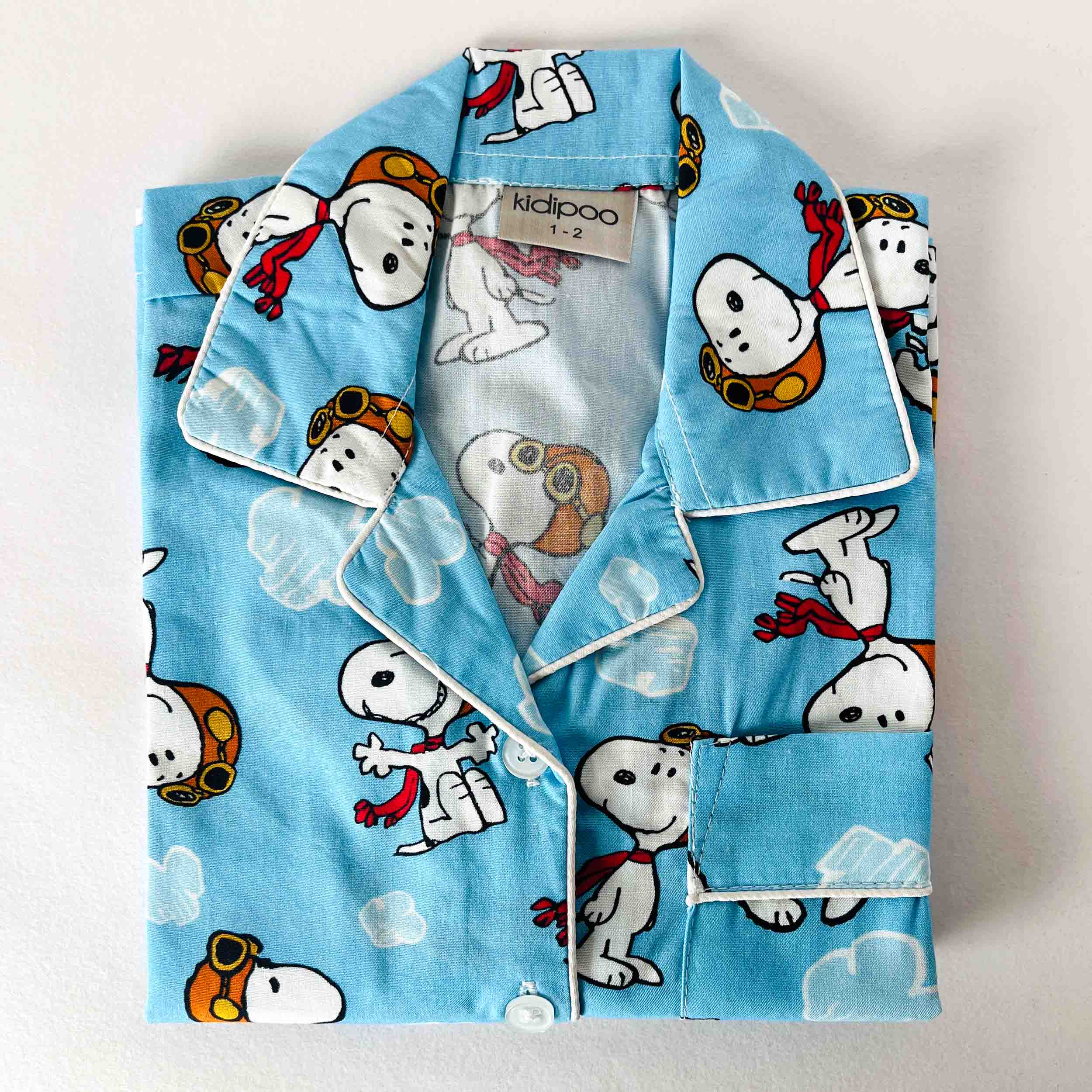 Children's pajama set with cartoon character design on a light blue background