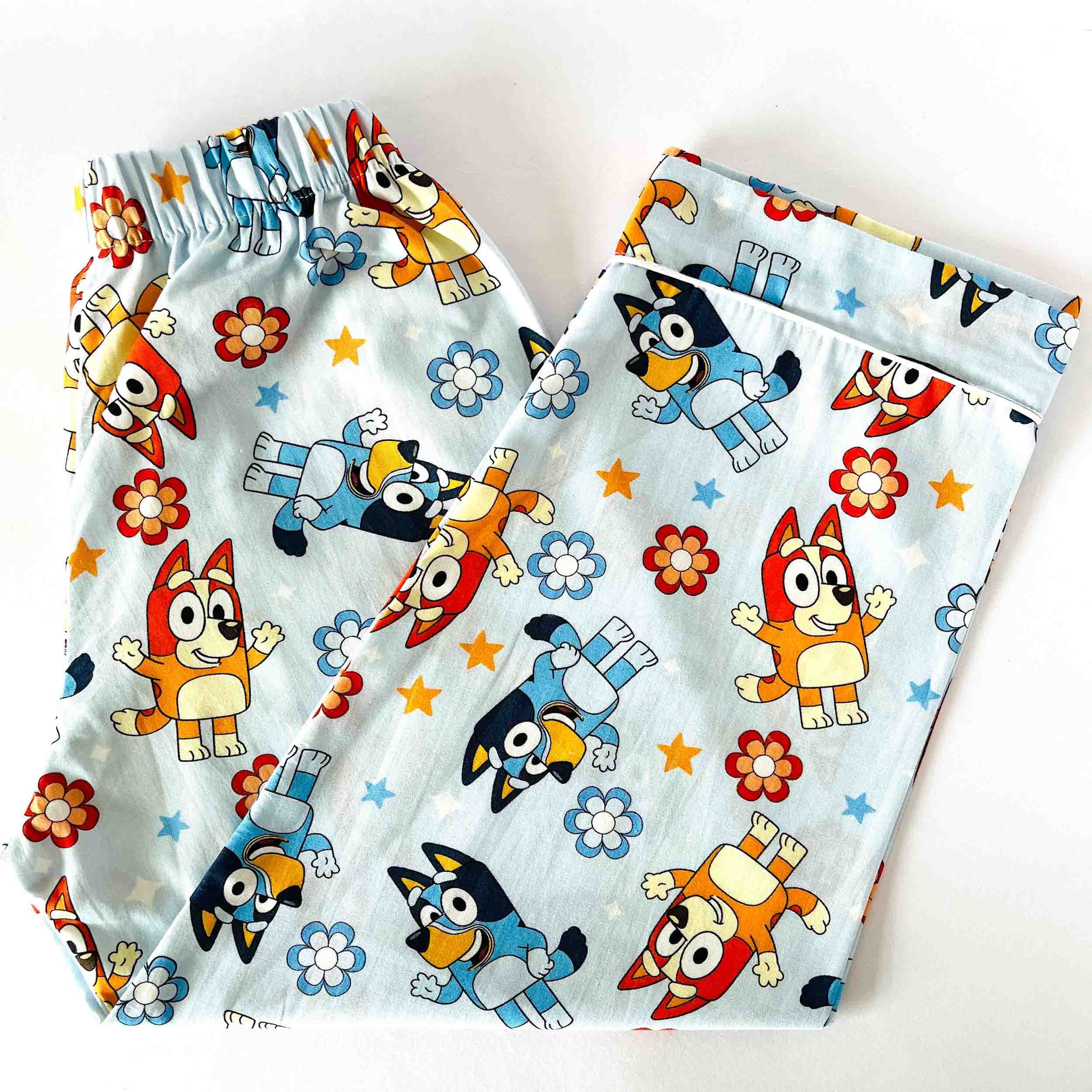 Kids blue cotton pajama pants with elastic waist cartoon character and floral print