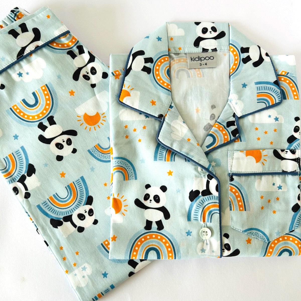 A set of children's pajamas with short sleeves, predominantly in a blue color, decorated with panda bear illustrations and other playful designs.