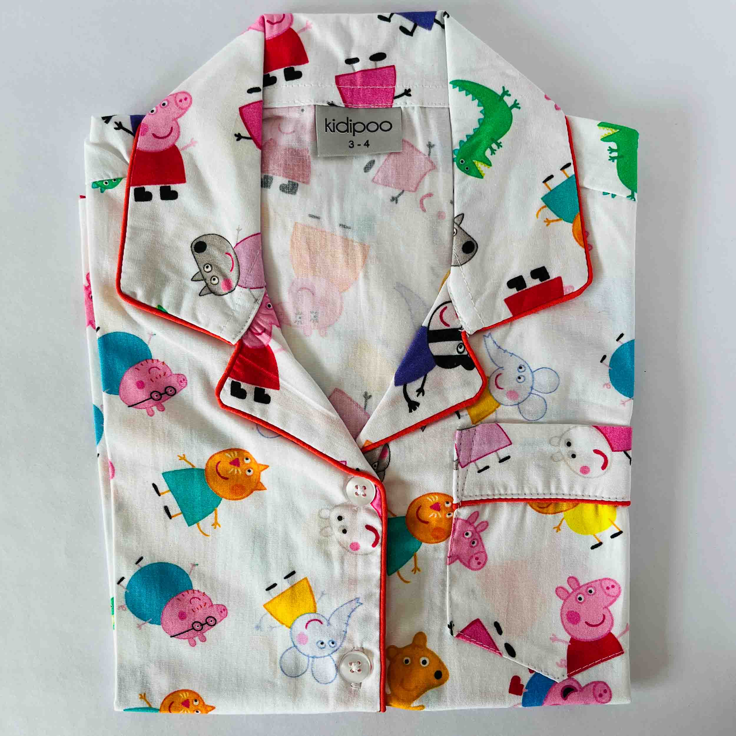 Children's pajama set with peppa pig cartoon character pattern on a light gray background