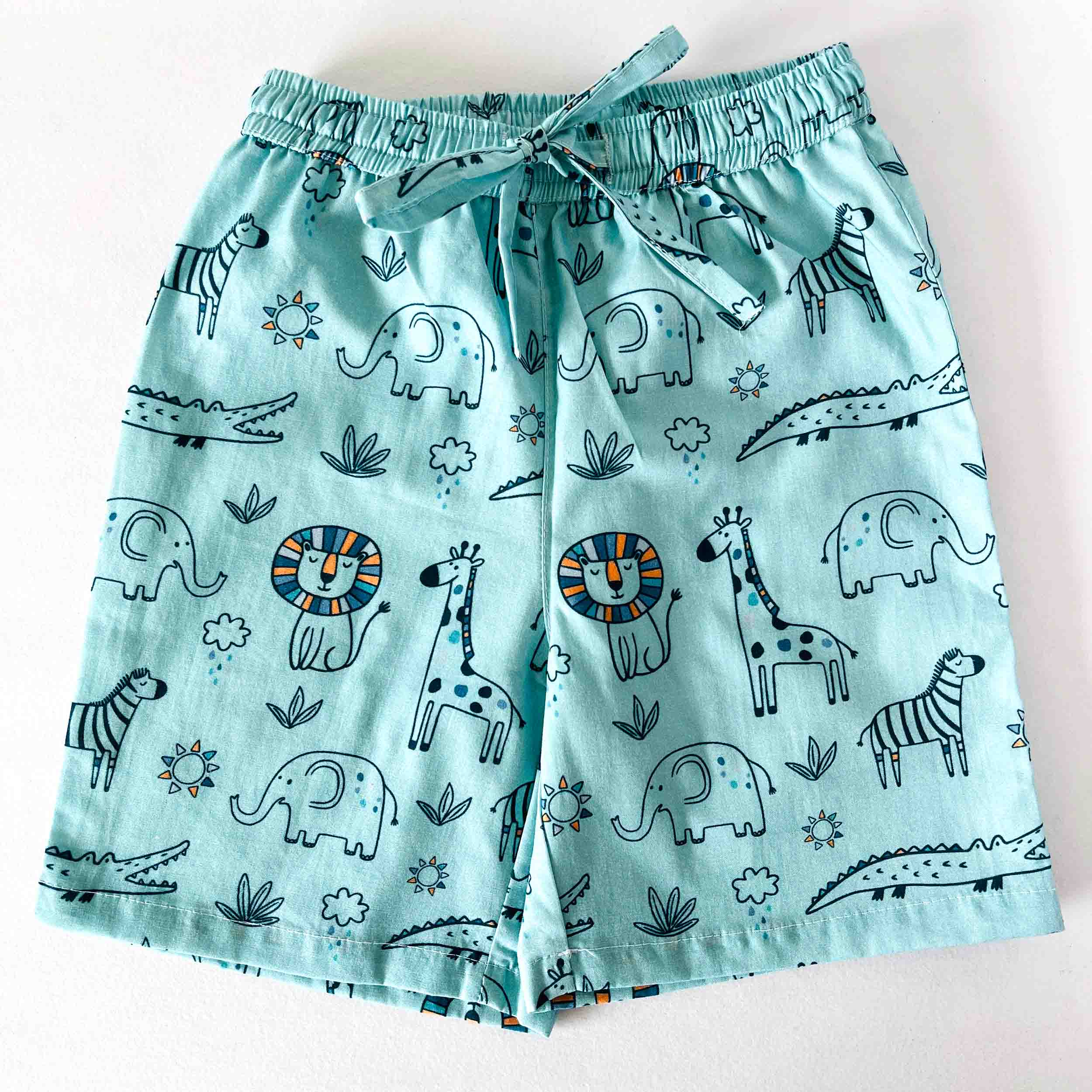 Children's shorts with animal pattern on a light blue background