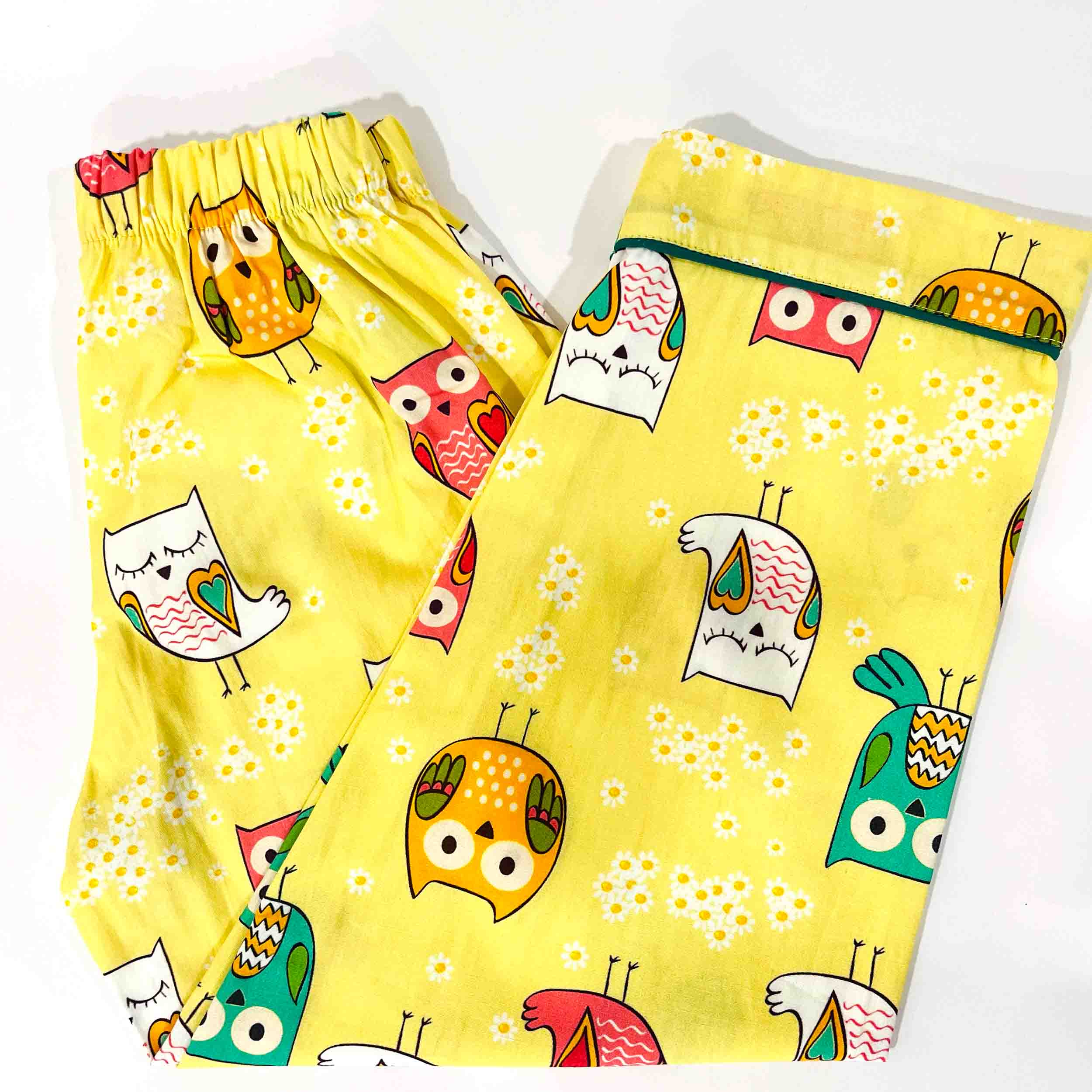 Yellow pajama pants with colorful owl patterns on a white background
