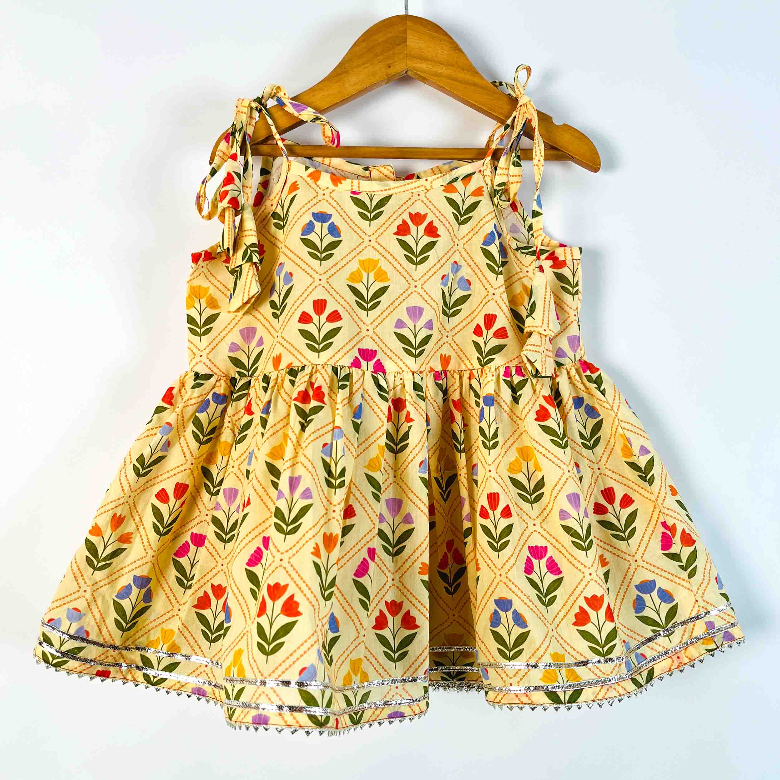 Girls Yellow Petals sleeveless tie-up printed cotton kurti front view with floral print