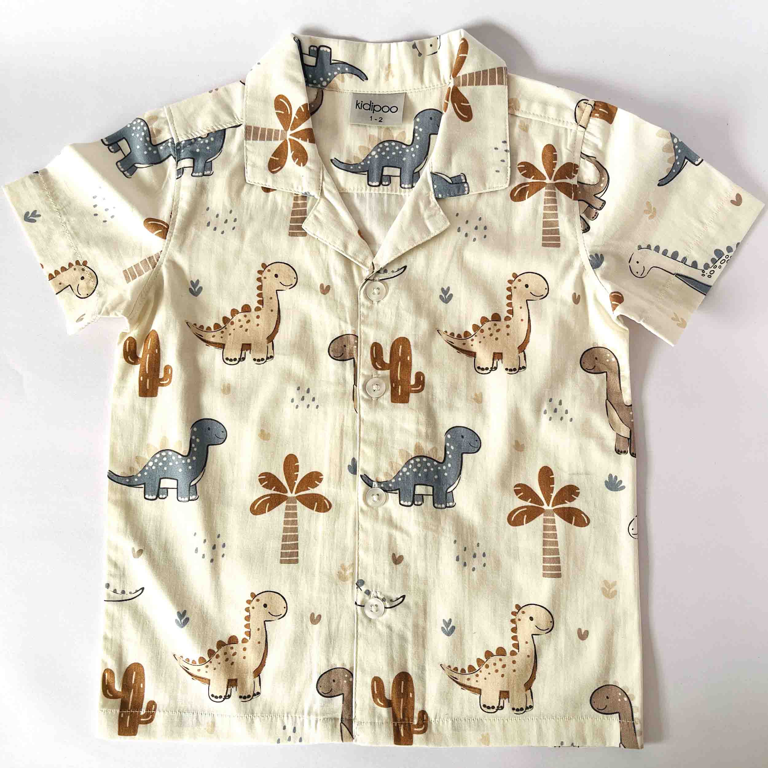 Children's shirt with dinosaur pattern on a white background
