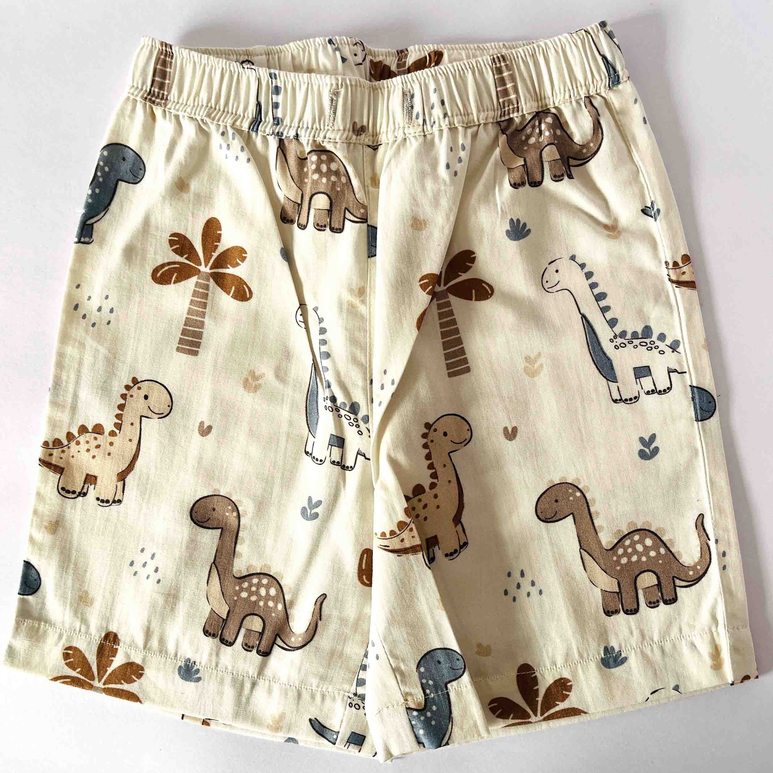 Children's shorts with dinosaur pattern on a white background