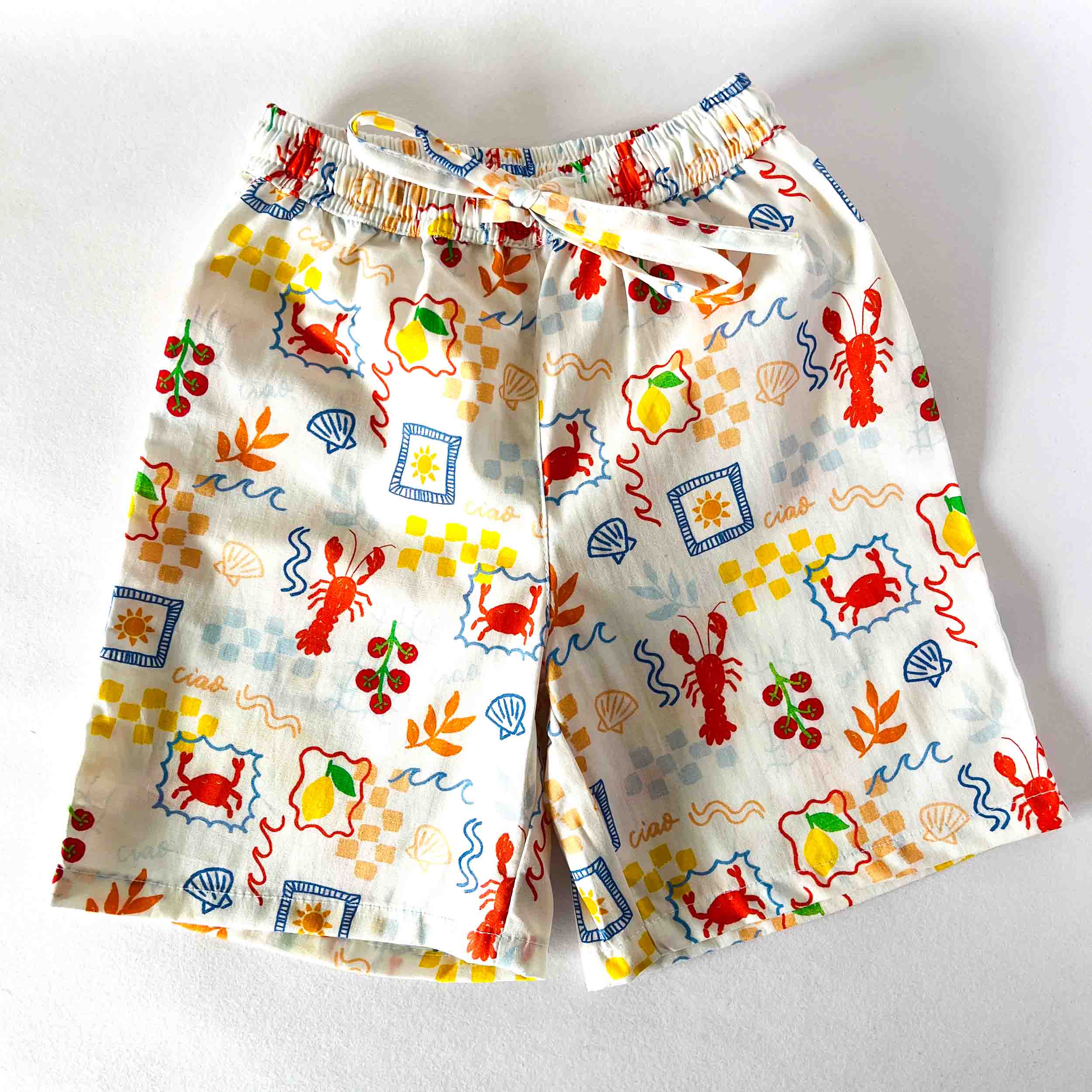Pair of pajama shorts with colorful sea-themed pattern on a white background