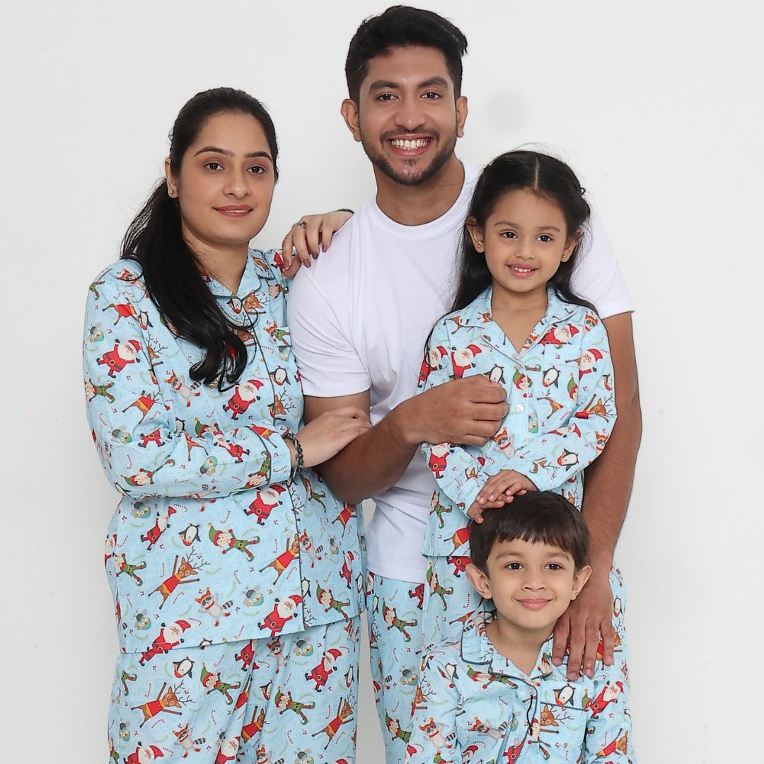 Family wearing matching blue Santa print cotton night suits Christmas sleepwear set