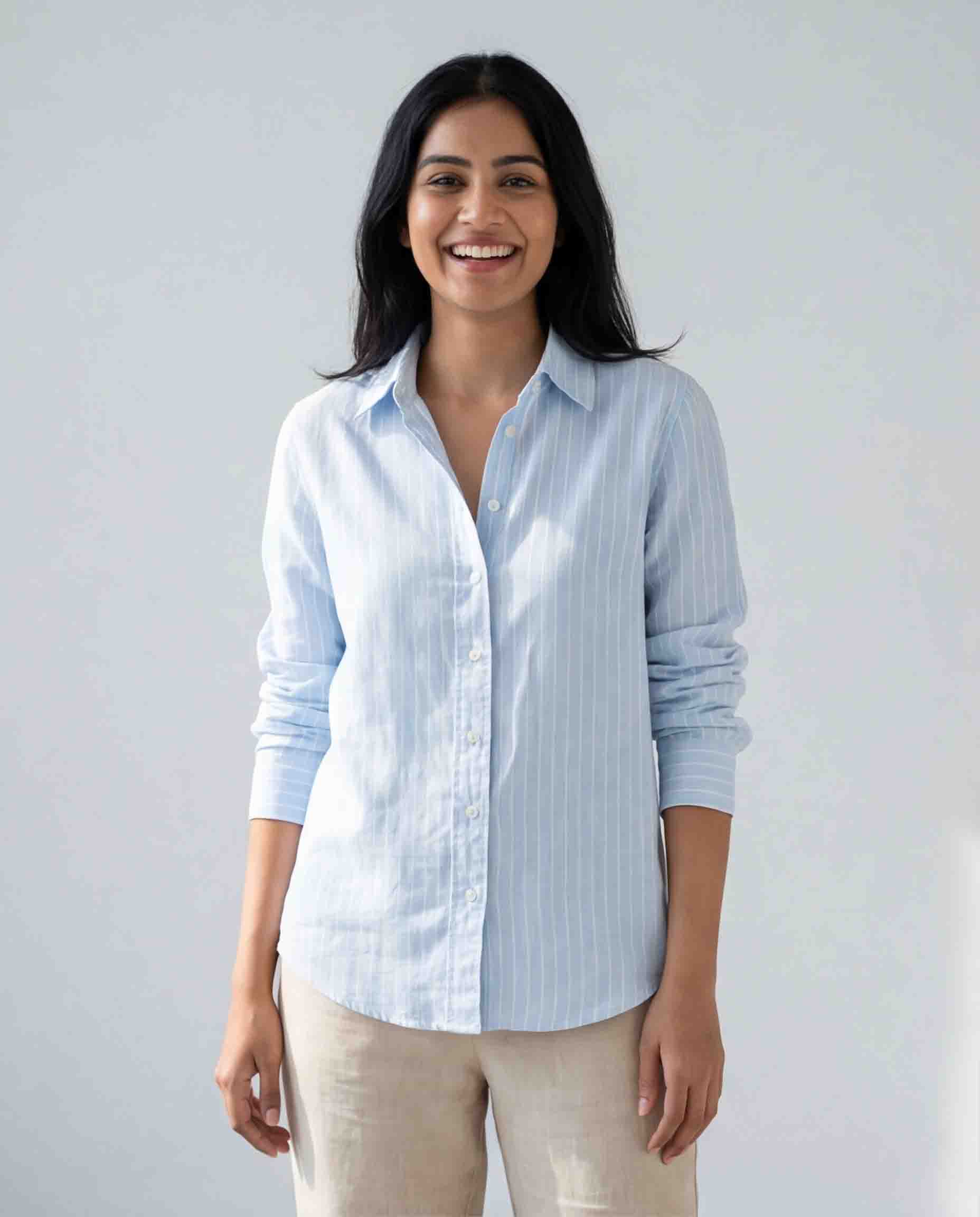 Woman wearing light blue striped cotton shirt front view casual formal wear