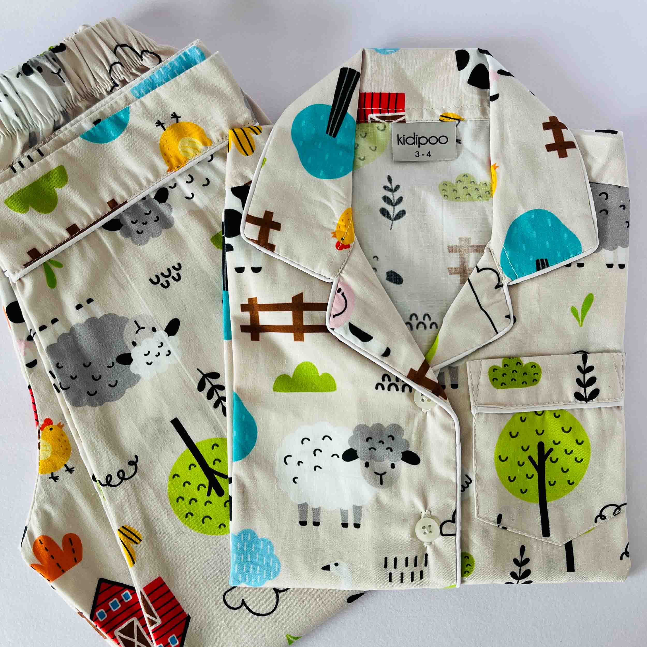 Children's pajama set with farm animal pattern on a white background