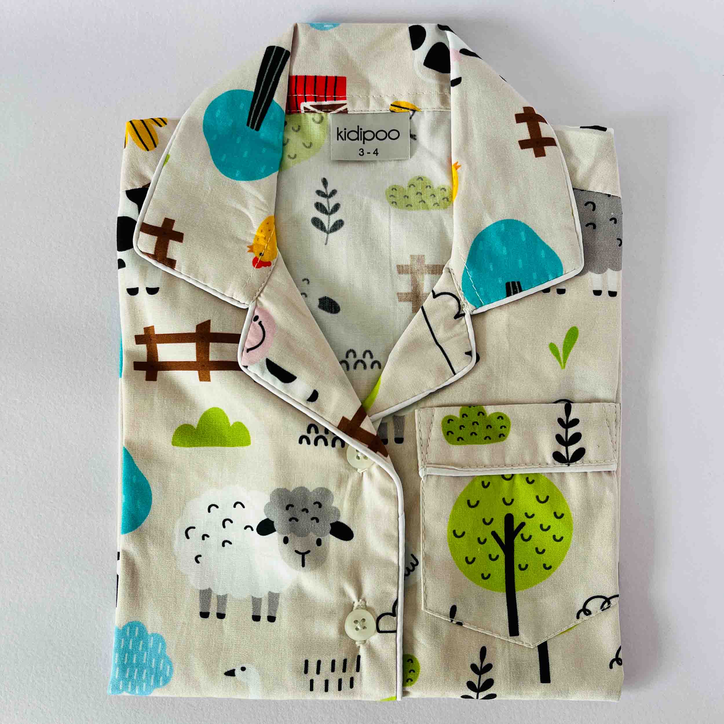 Children's pajama set with animal and nature patterns on a white background