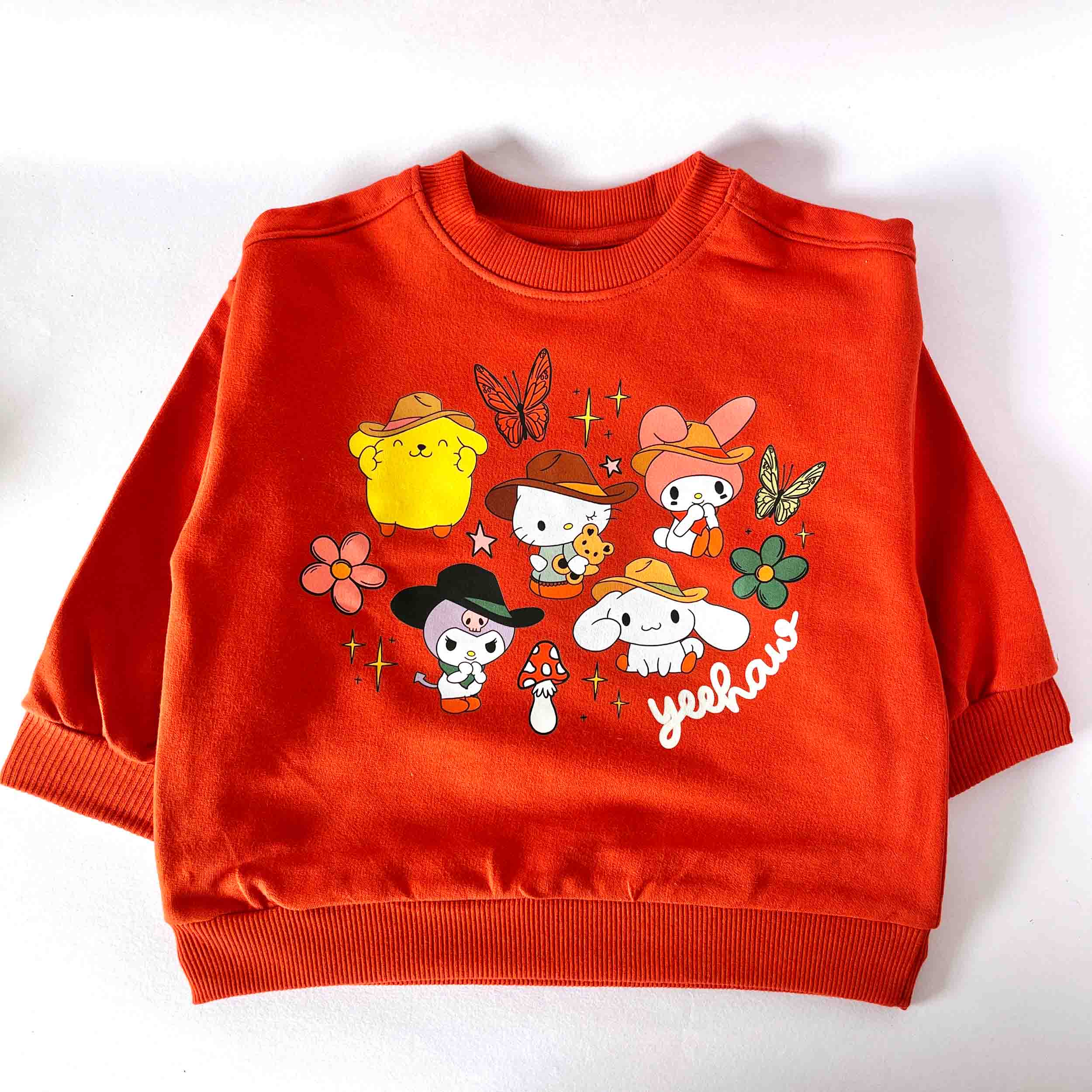 Red sweatshirt with cartoon characters and 'YEAH' text on a white background