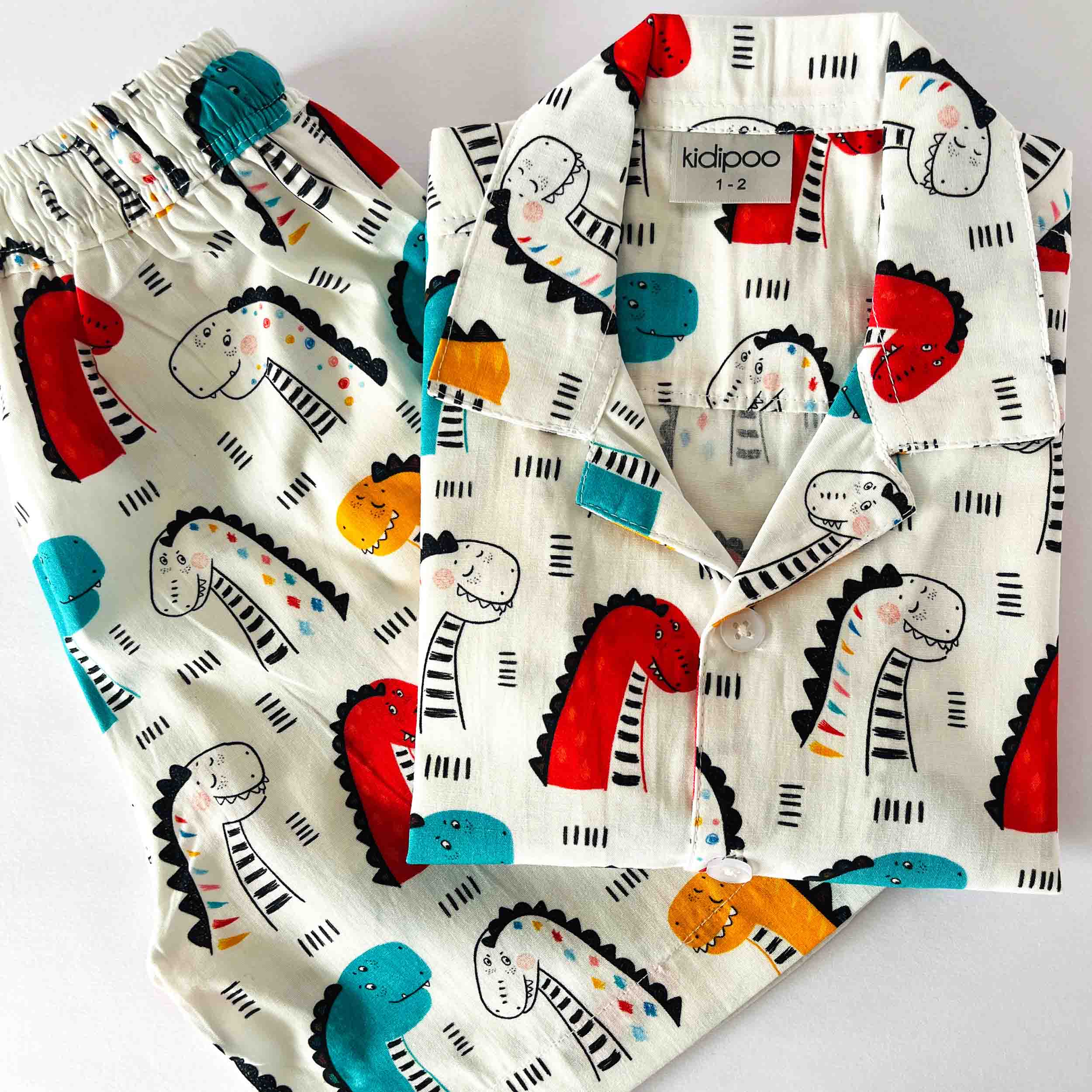 Children's shirt with dinosaur pattern on a white background