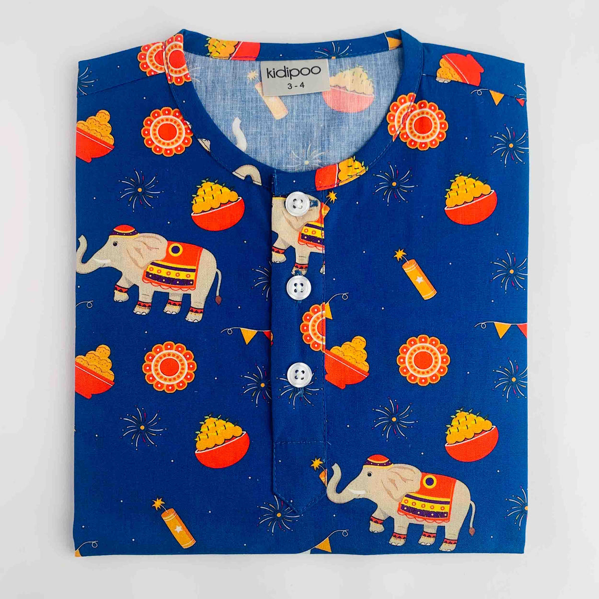 A folded blue children's long-sleeve top by Kidipoo, featuring a festive Diwali-themed print with elephants, glowing bowls, fireworks, and orange decorative motifs. The Kurta has a button-down front with white buttons and is displayed flat against a White background.