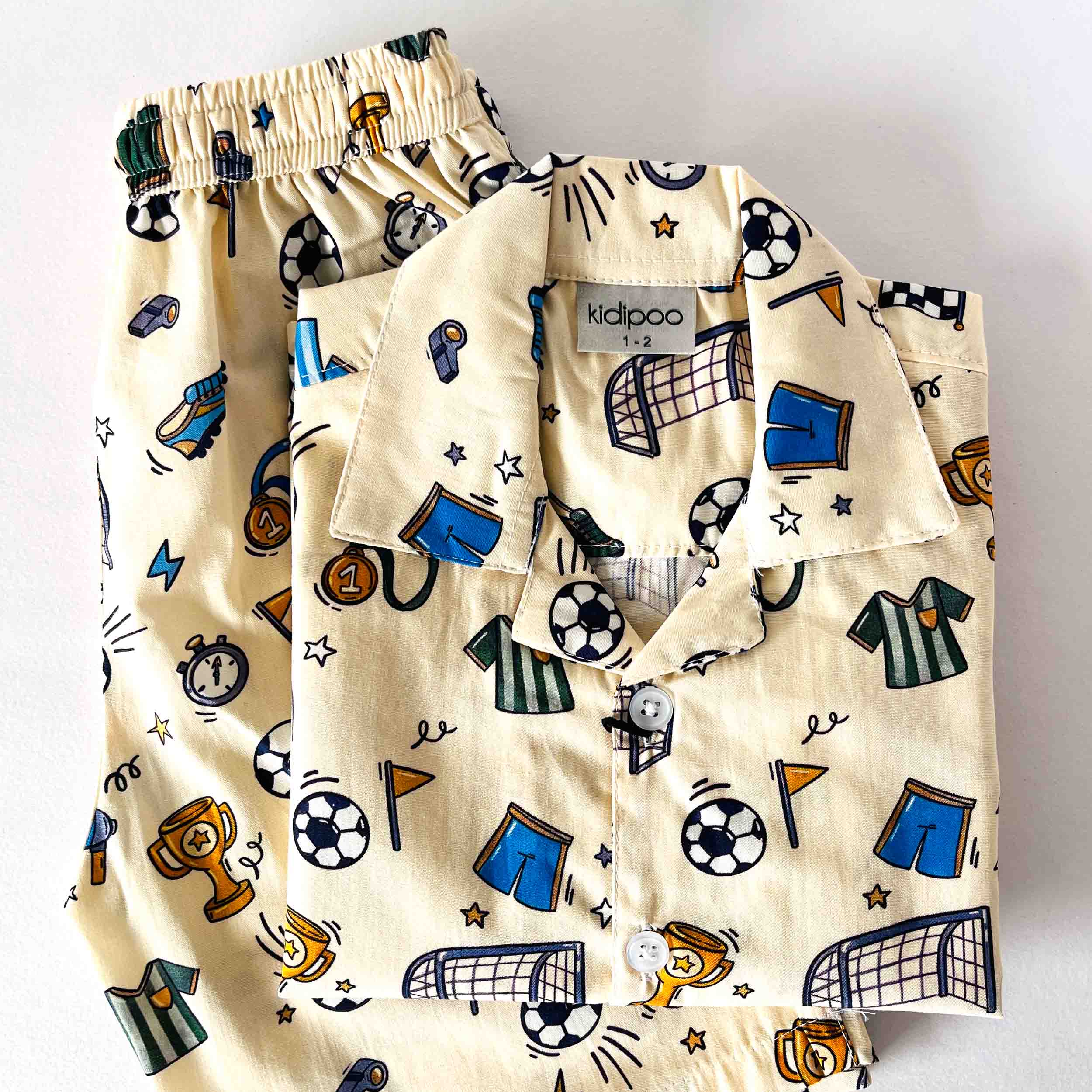 Children's pajama set with sports-themed design on a white background