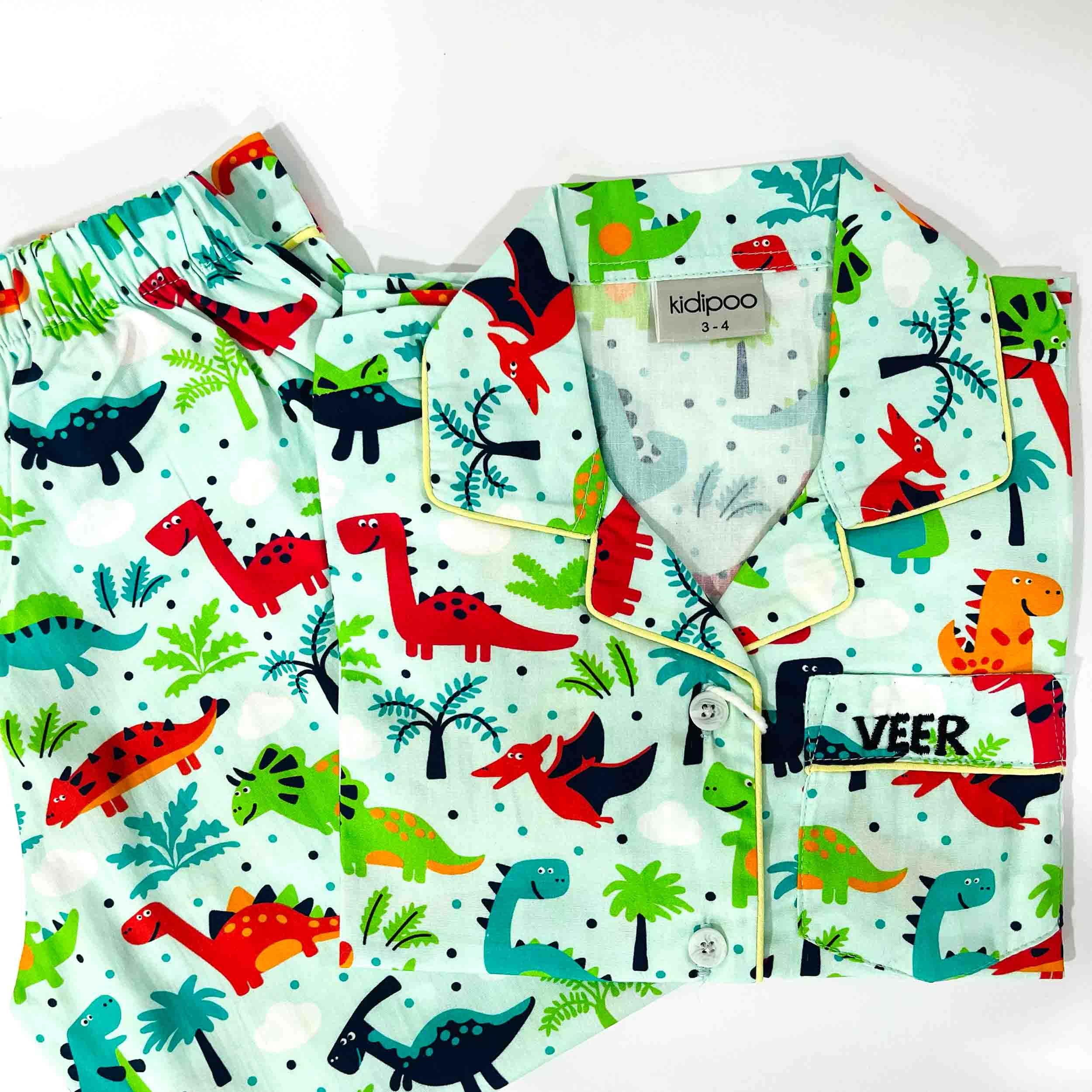 Children's pajama set with dinosaur pattern on a white background