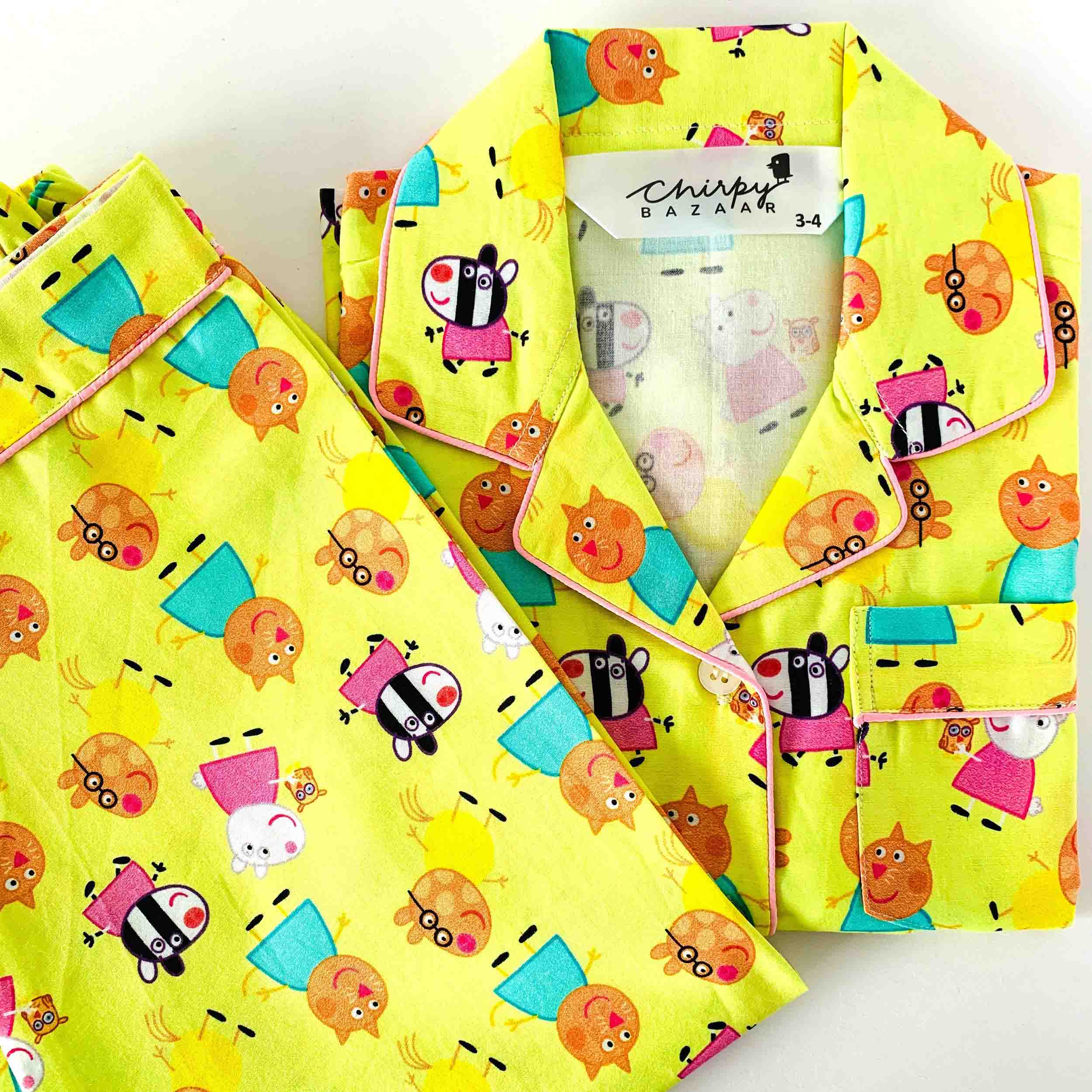 Yellow children's outfit with cartoon character pattern on a white background