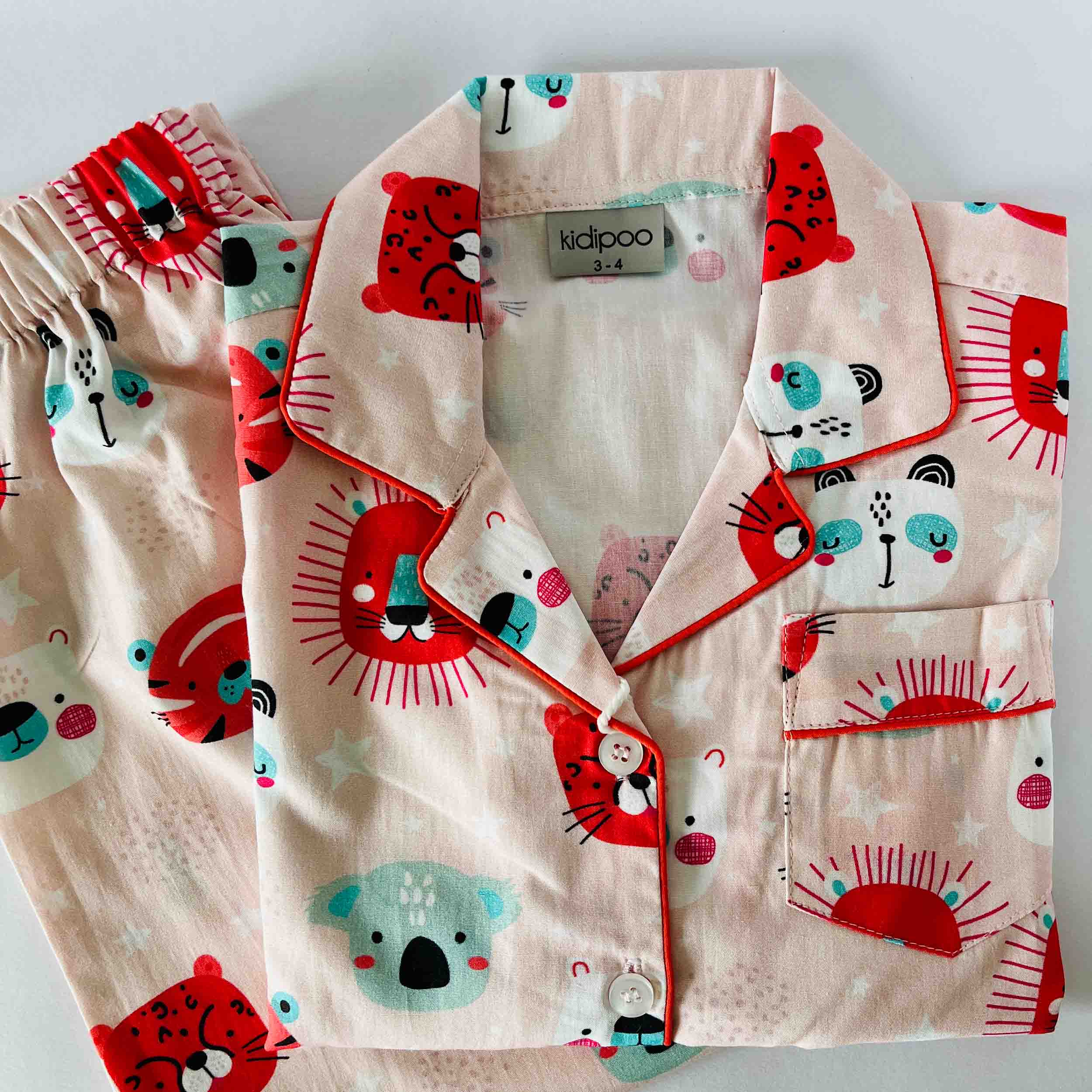 Children's pajama set with animal patterns on a light background