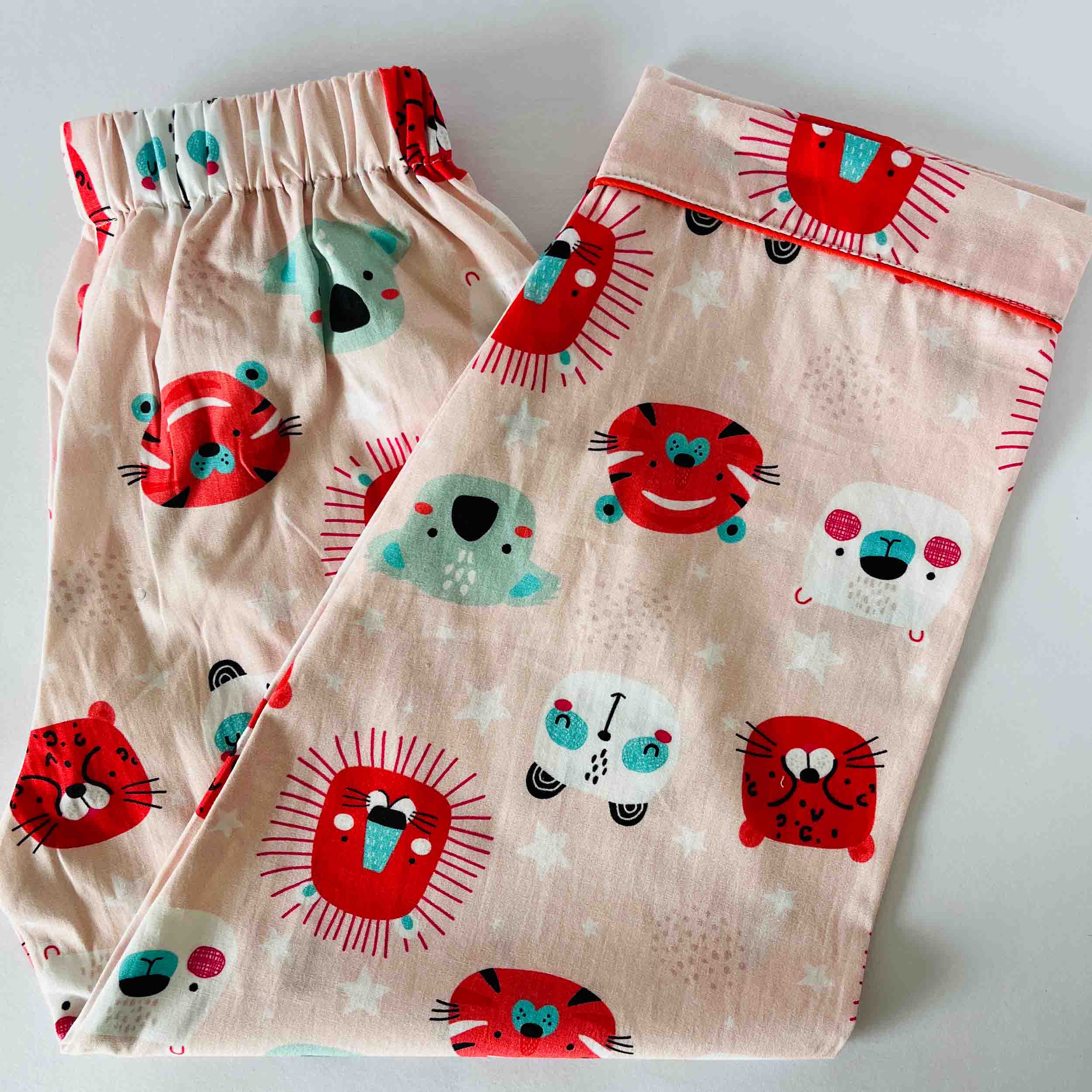 Children's pajama set with animal patterns on a light background