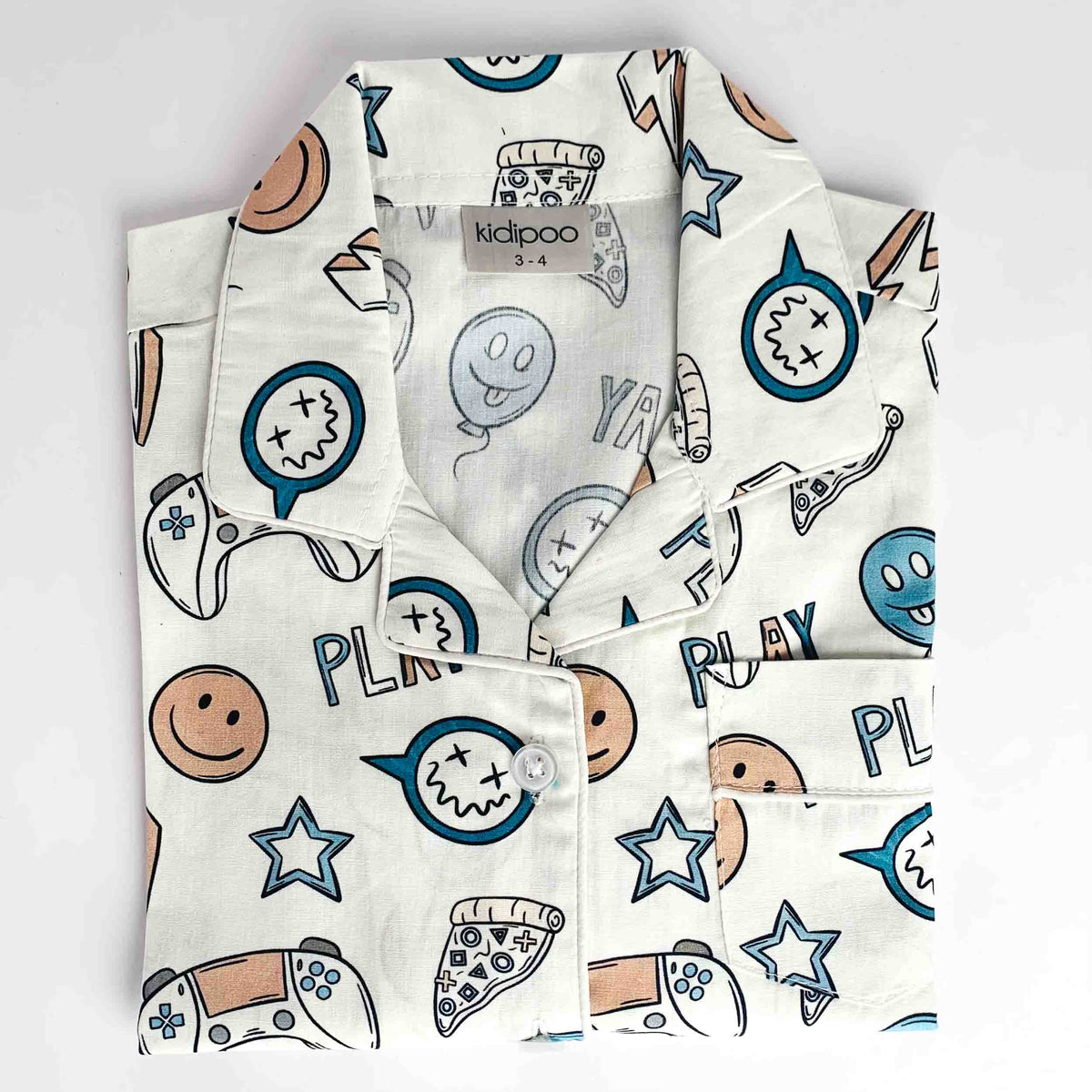 Gaming Squad printed kids' night suit shirt with smiley faces, stars, game controller, pizza, and playful graphic patterns on a white background.
