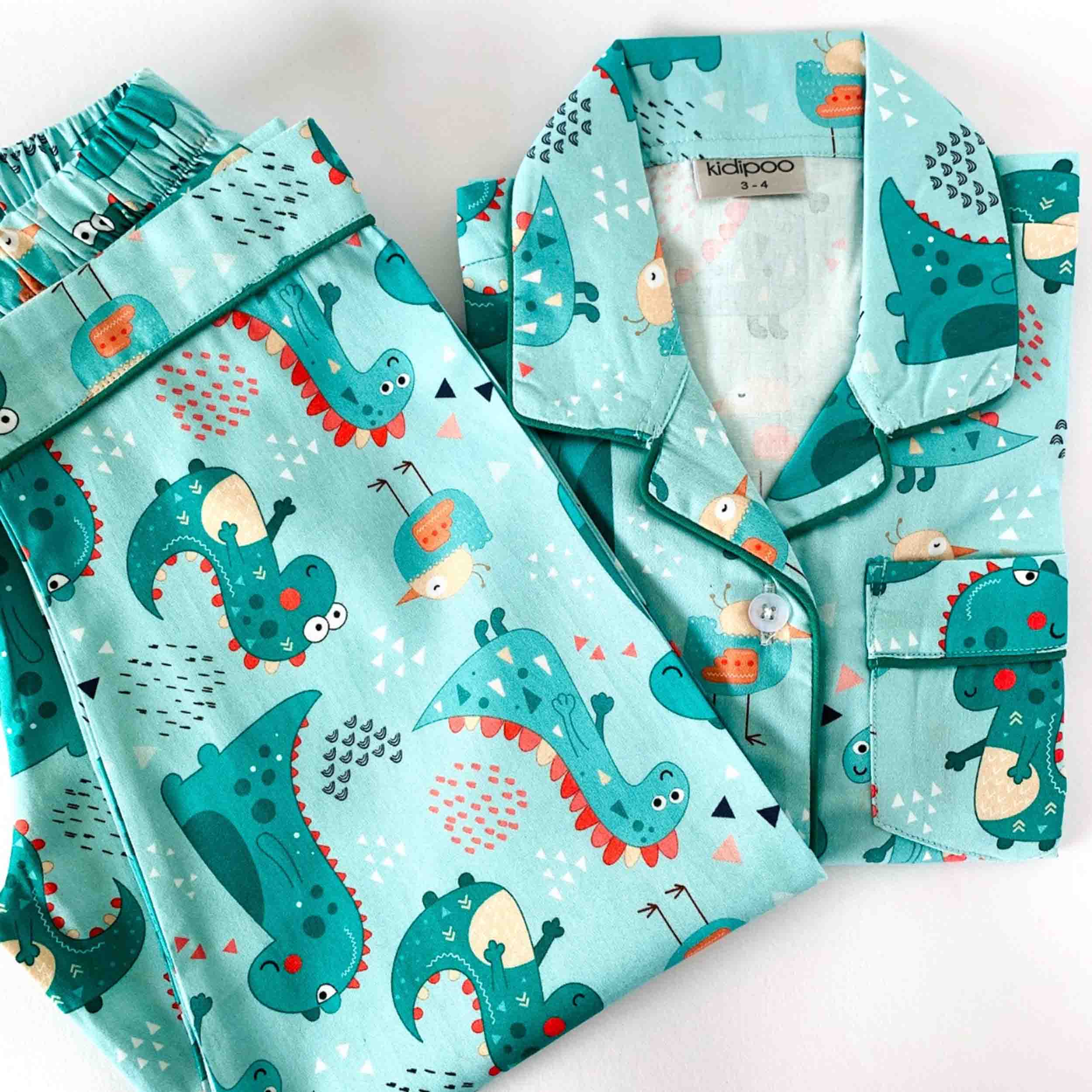 Children's pajama set with dinosaur pattern on a light blue background