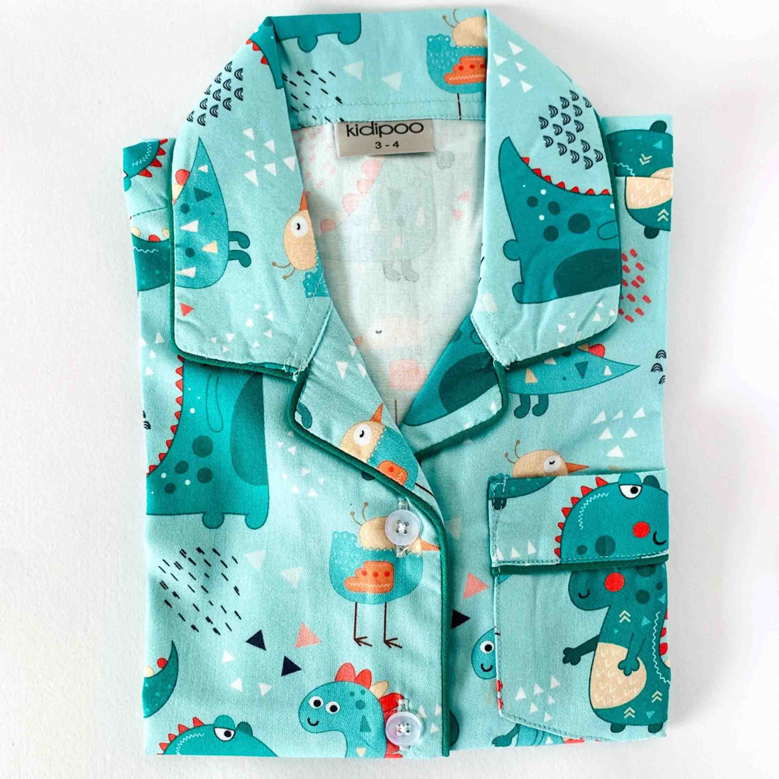 Children's pajama set with dinosaur pattern on a white background